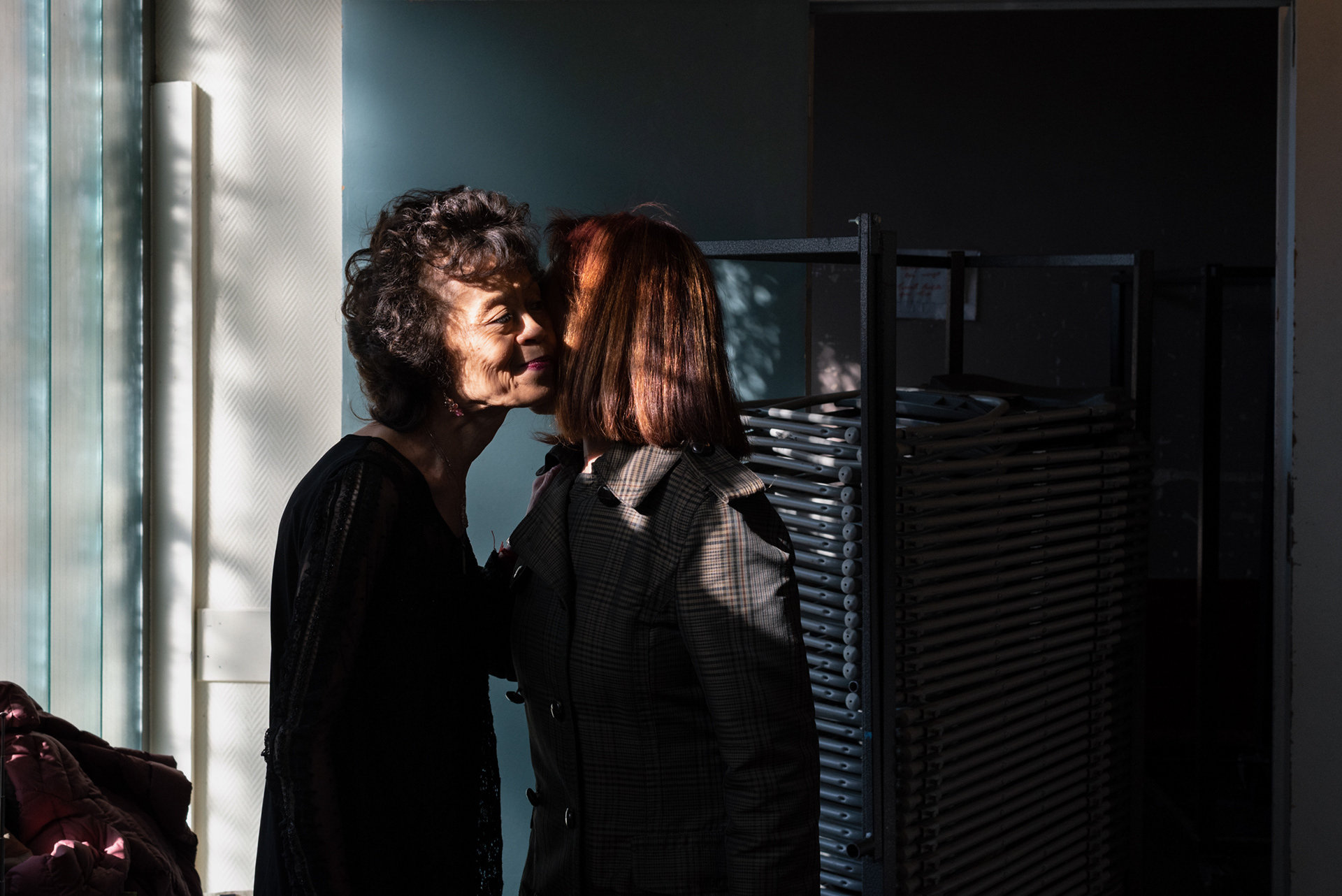 Ya Fen and Agnes Lam greet each other by exchanging kisses on the cheeks (faire la bise) at their weekly dance lesson.