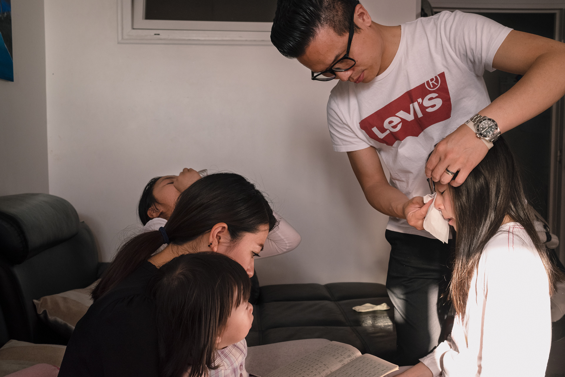 Zhang Huan Dong wiping tears off his second daughter Kelly Zhang. Kelly was worried about not being able to complete her homework for her chinese lessons.