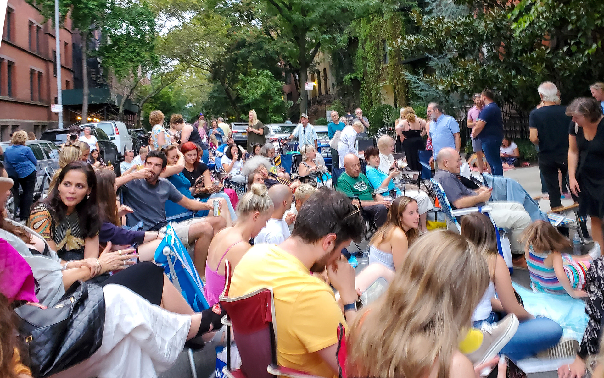 The audience gathers. The street is closed to traffic.