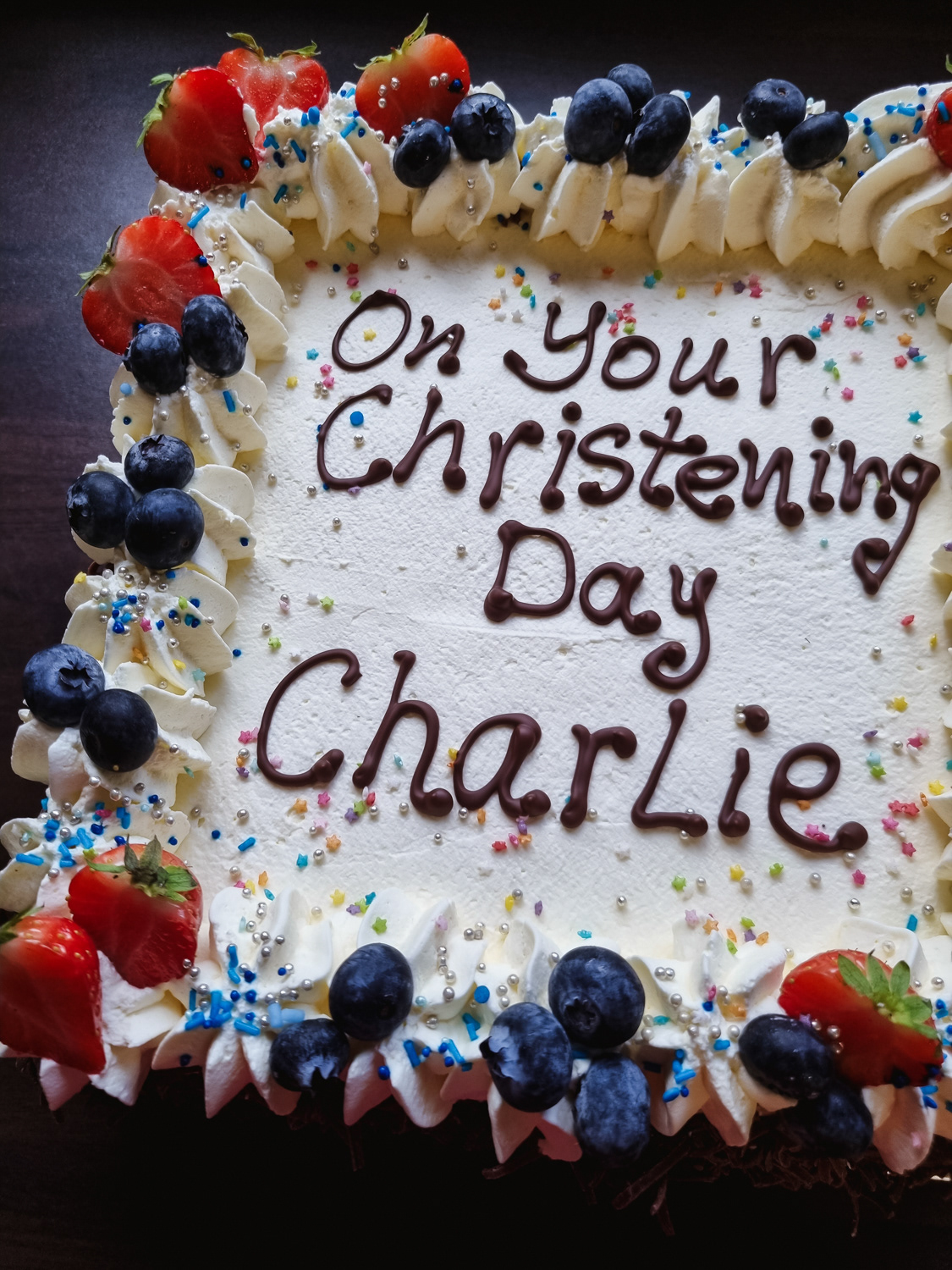 Christening Cream cake with strawberries and writing on top