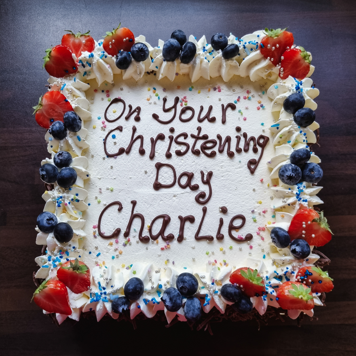 Christening Cream cake with strawberries and writing on top