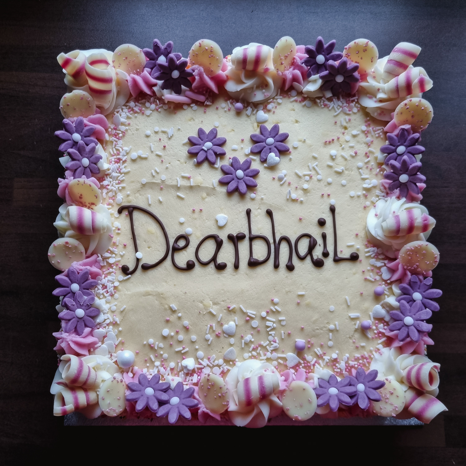 Vanilla buttercream cake with purple decorations