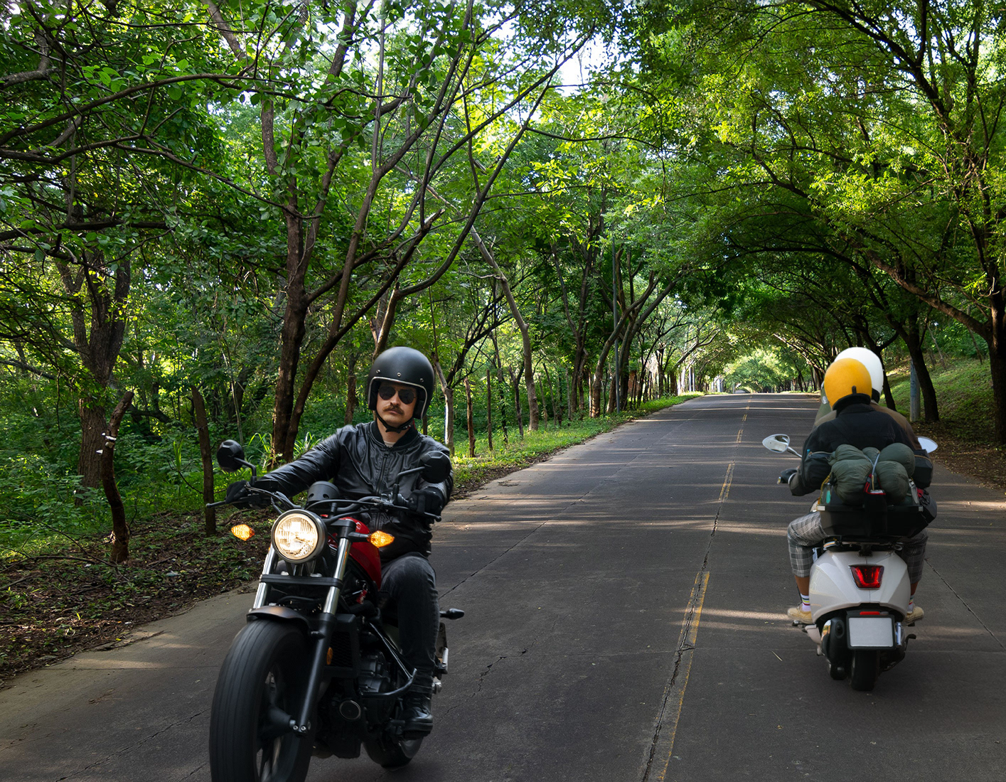  Add a person wearing a yellow helmet riding a white scooter in the right lane.