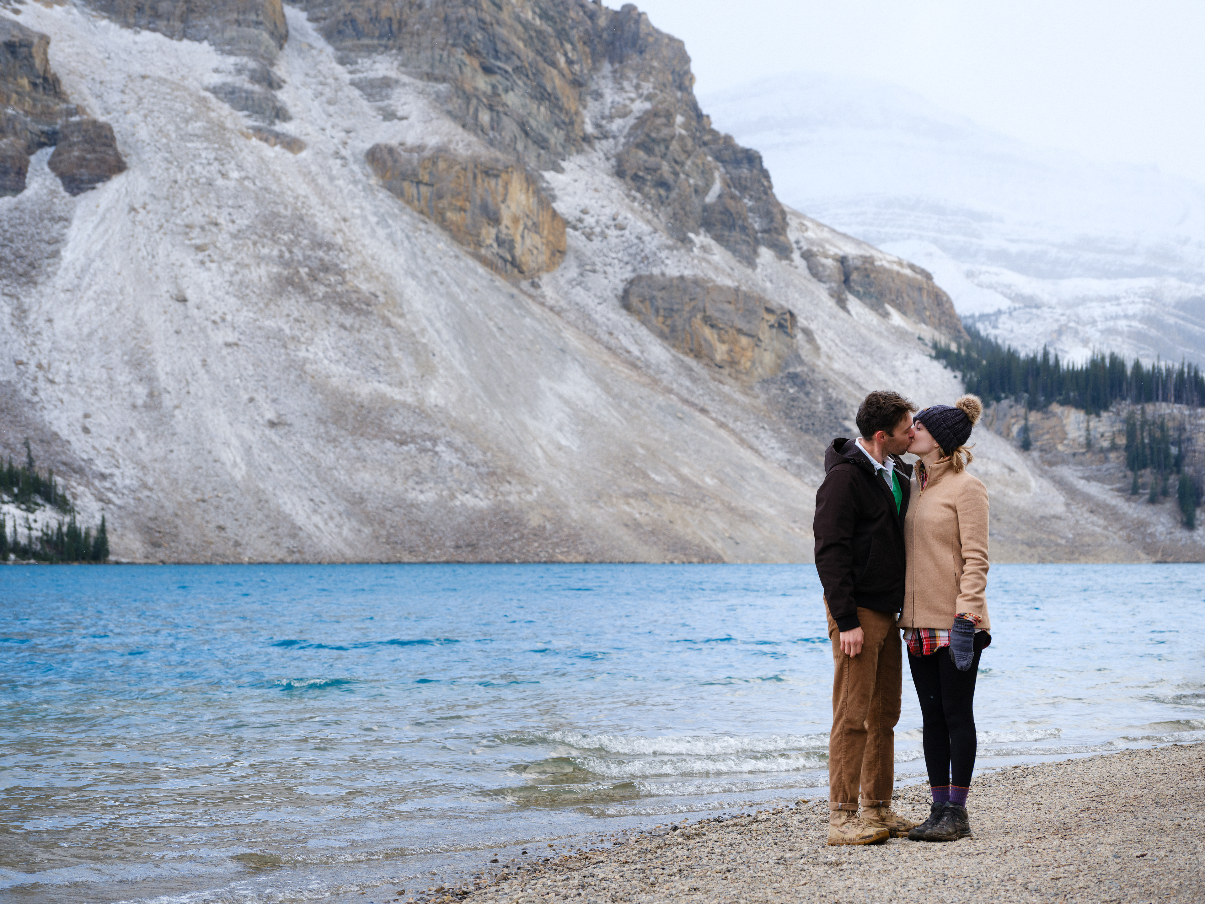 Couple kissing at Bow Lake in Banff National Park during a proposal photo shoot