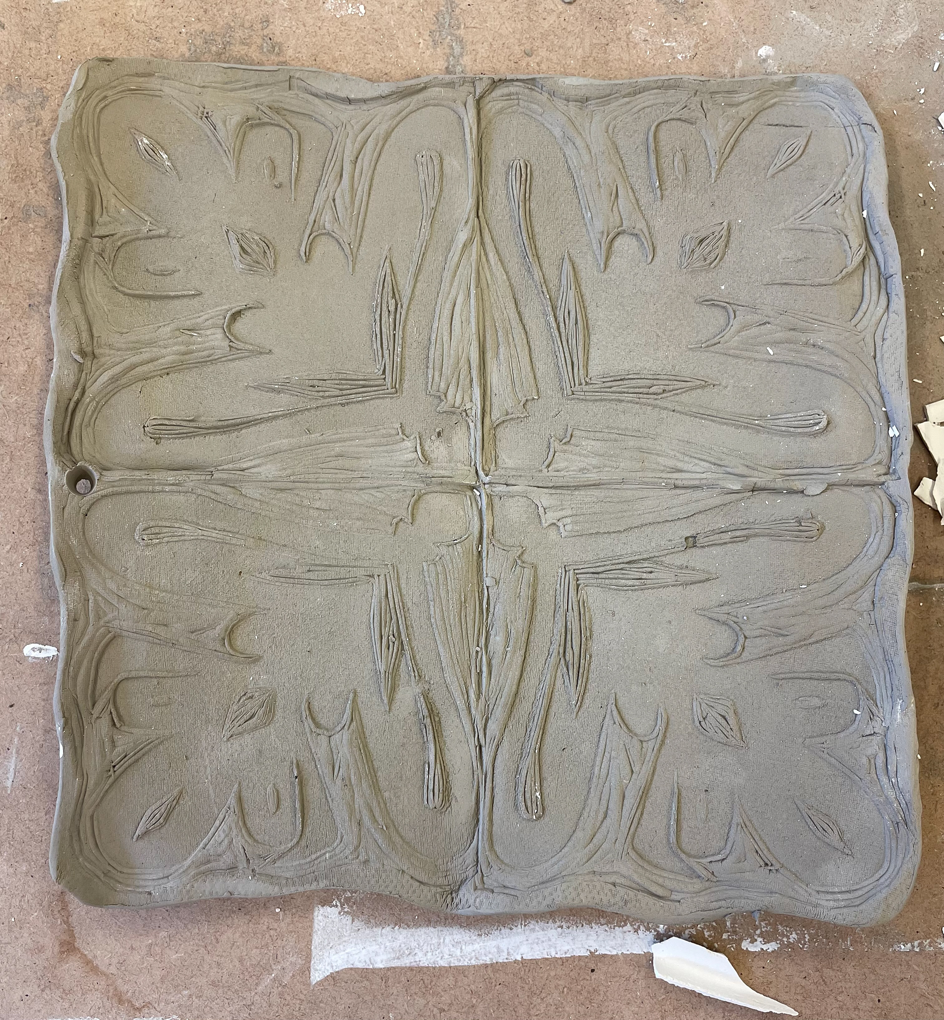pressing lino into clay