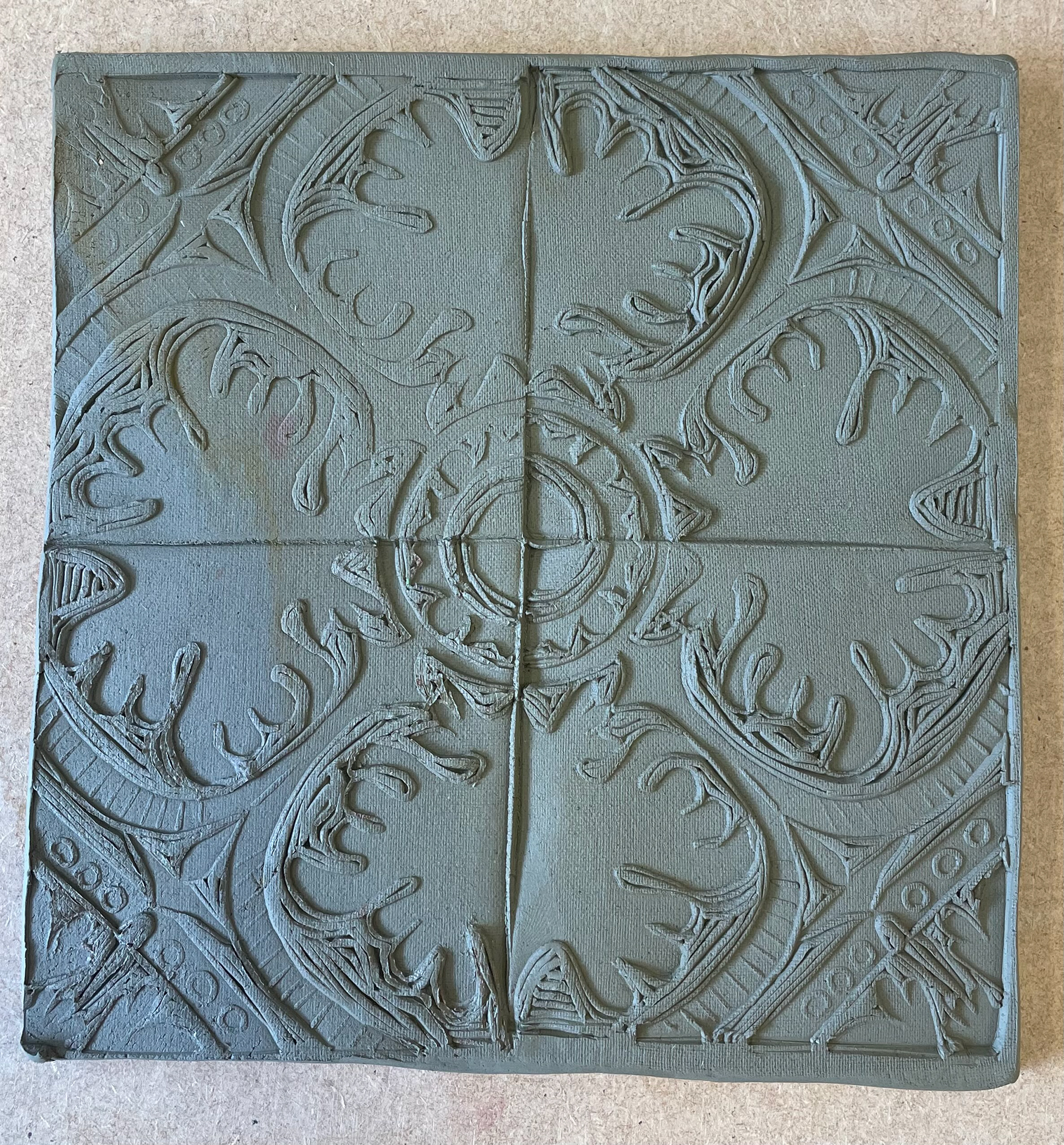 pressing lino into clay