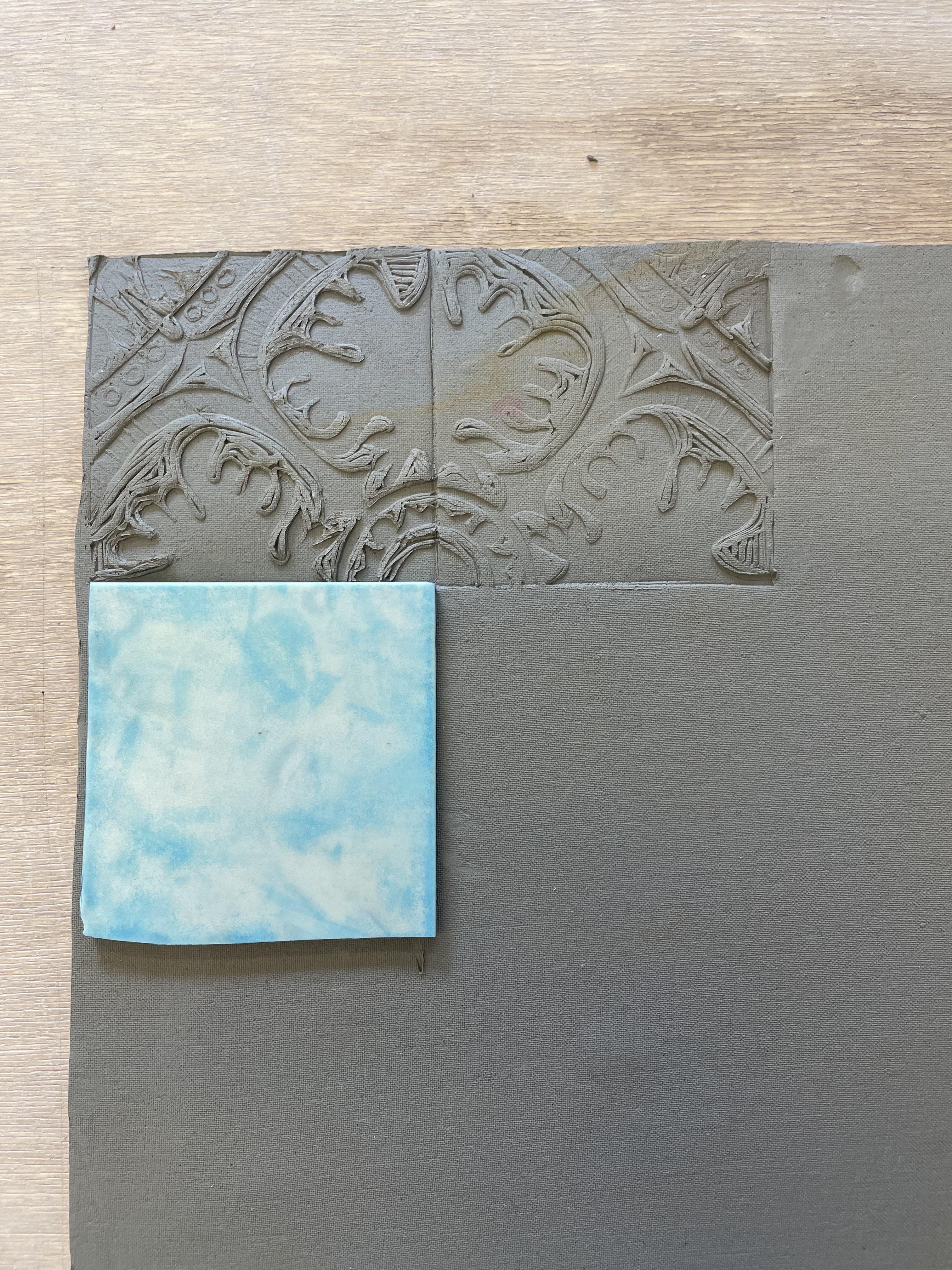 pressing lino into clay