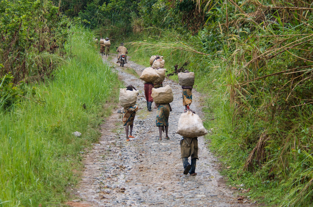 Women start the 2-3 hour gruelling trek carrying rocks from Adidi gold mine, at weights up to around 60 kgs to the workshops where they will be crushed.