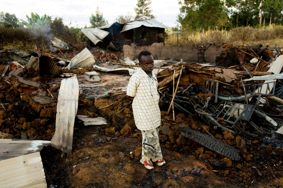 An 11 year old survivor at the remains of a church burnt on 1st January 2008, where at least 18 people died, during post election violence in Kenya.