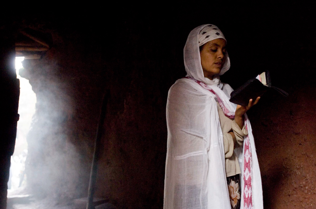 A worshipper reads her bible at St George’s church, one of 13 monolithic churches dotted around the high plateau of Lalibela, medival capital of orthodox Christian Ethiopia.
