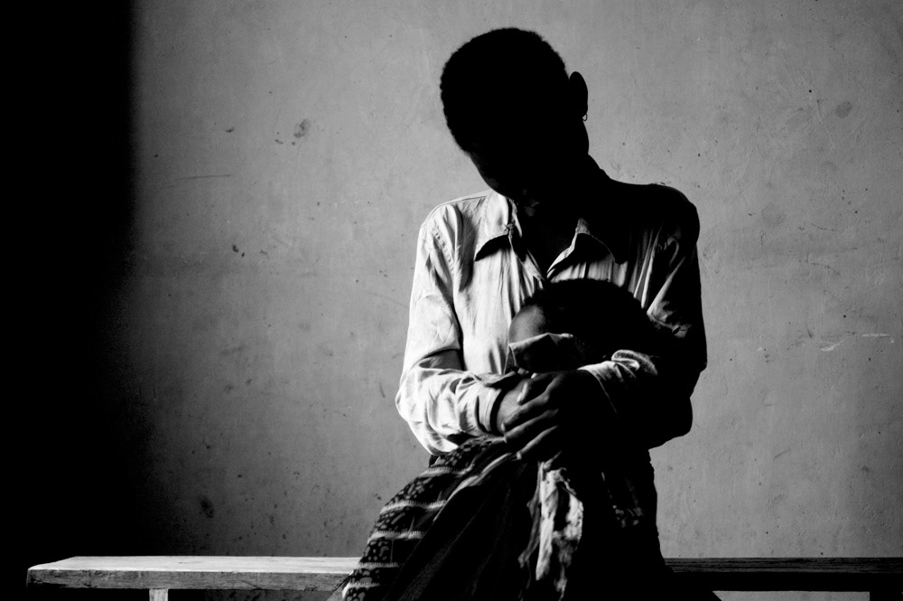 A victim of rape sits with her daughter, conceived during the attack.