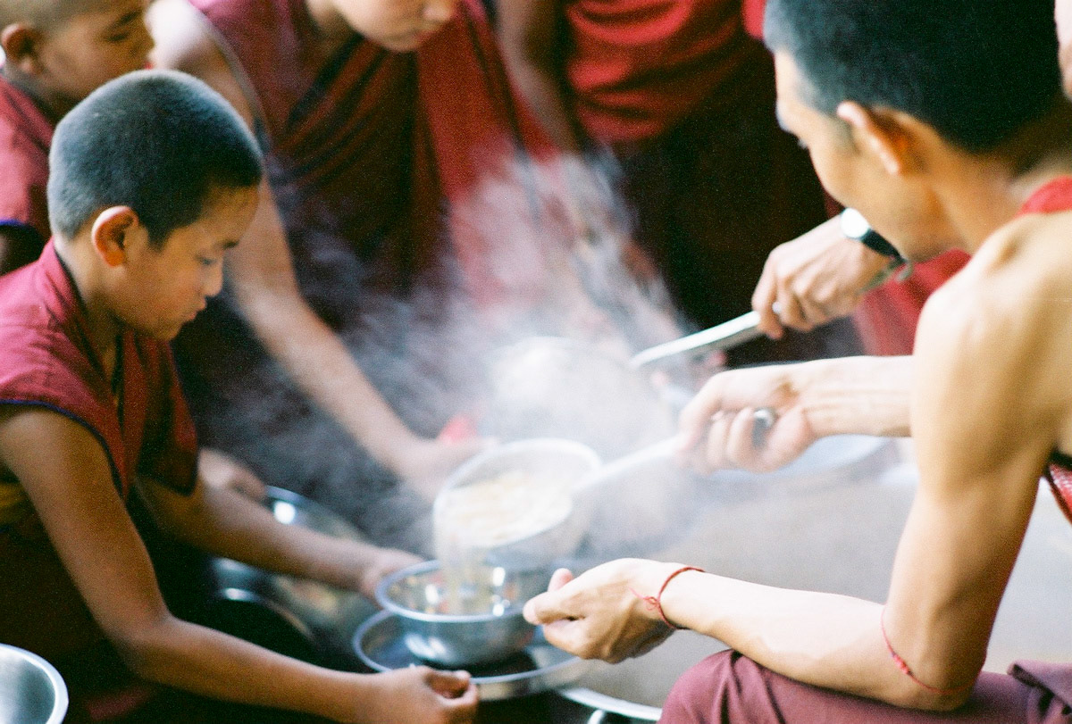 Young monks collect their food, Tashi Lhunpo Monastery, Southern India