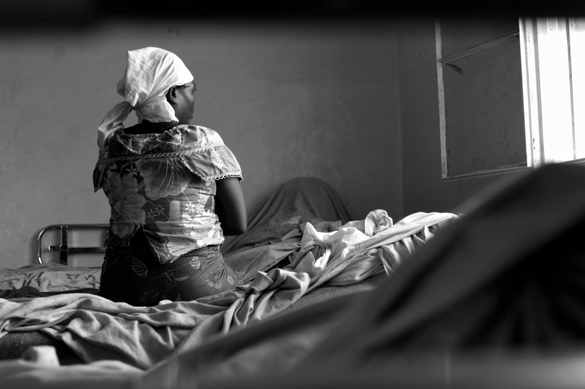'Bernadette', 50, sits on her hospital bed at HEAL Africa where she is being treated for fistula. She was raped in 2002 when harvesting cassava, a one hours walk from her home.“They came from behind, there were three men. Two of them raped me and the third went to a nearby field and raped a women there. I was three months pregnant. I cried and they told me if I continued they would kill me. They had guns. They beat me with their hands and trod on me. Four months later I aborted and contracted fistula. My husband told me we could no longer be together, as those people (who had raped her) may have left a disease in me. I feel so much pain, I don’t know when I will get rid of the burden of having fistula, it makes me feel so so sad.”