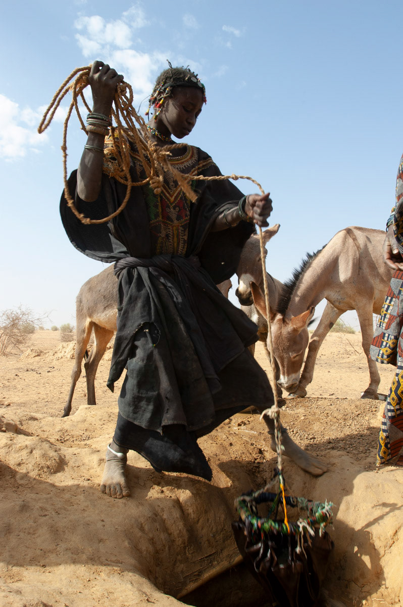 .A young Nigerien girl from the slave caste collects water from a traditional well in far west Niger.