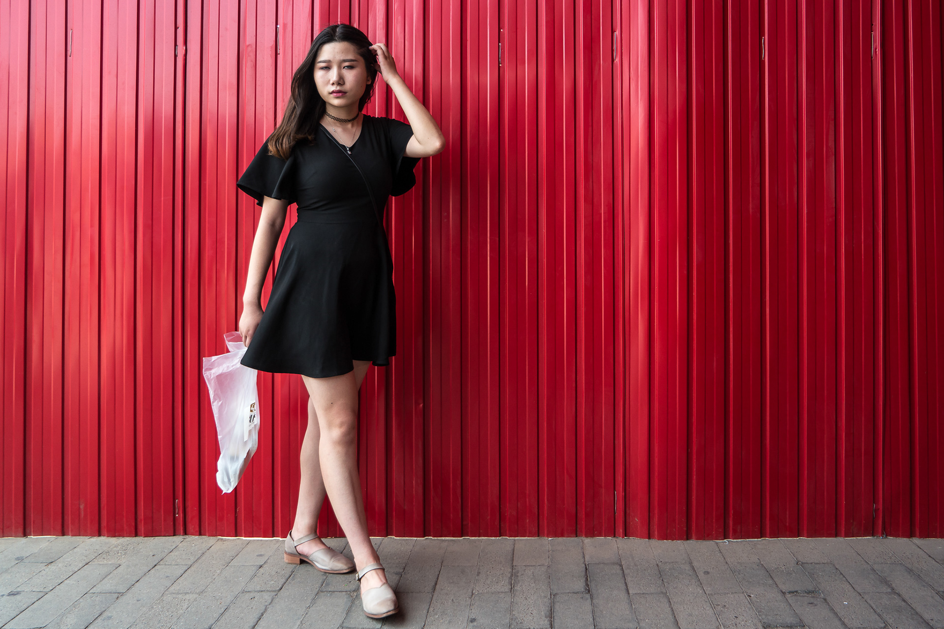 Woman at Red Wall