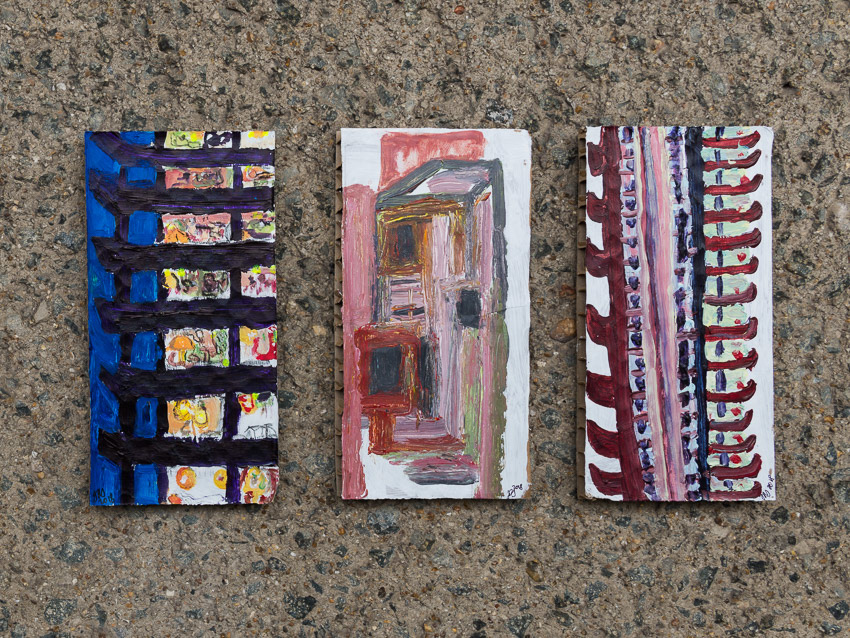 From left: Barbican Tower Block At Night; Centre: The Colour of Concrete (Barbican Roof Air-Vent); Right: Barbican Tower Block Acrylic on recycled Dyson cardboard packaging 25 x 13 x 2 (each)