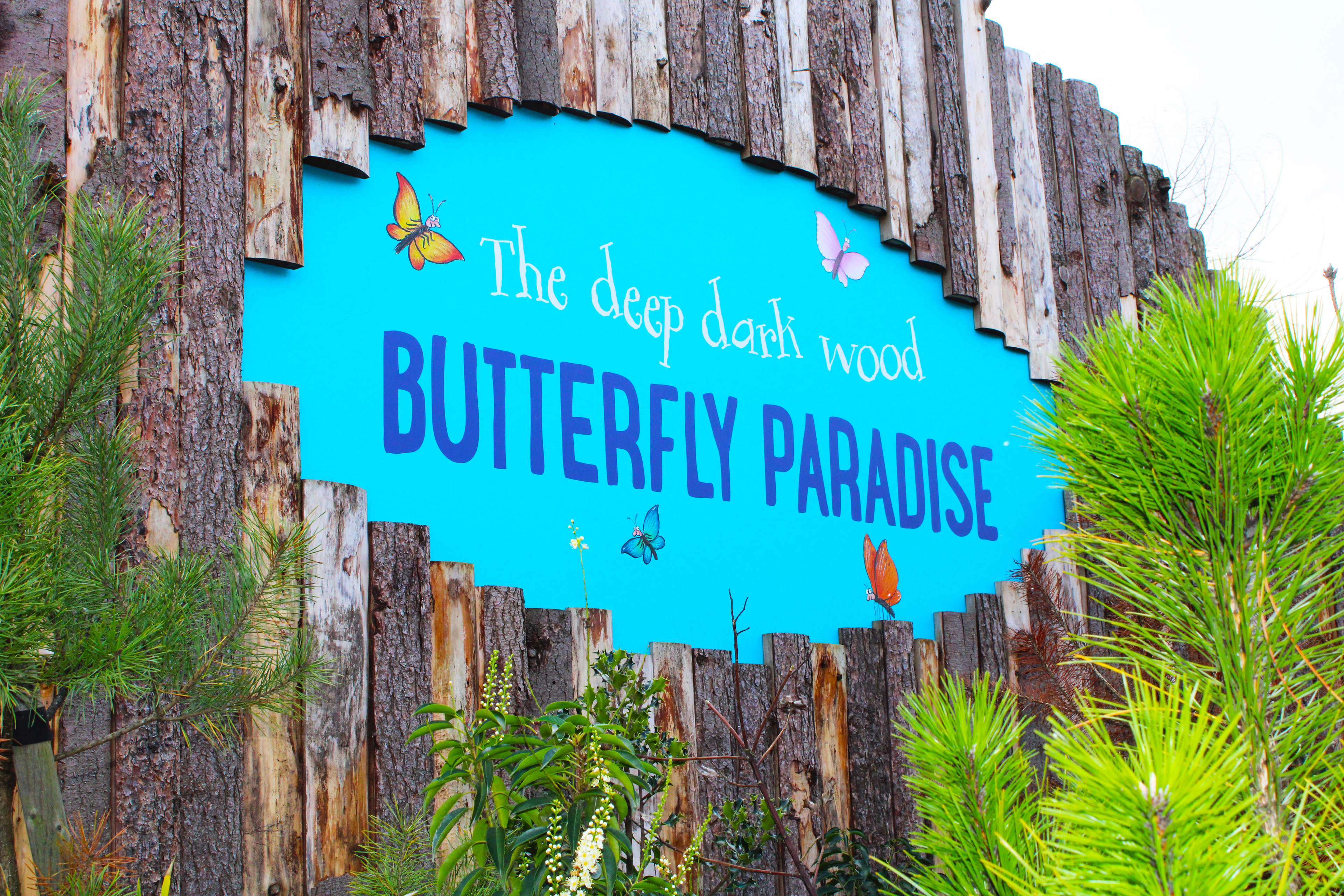 The Deep Dark Wood Butterfly Paradise - Main entry sign dibond digital print built in behind the building shell