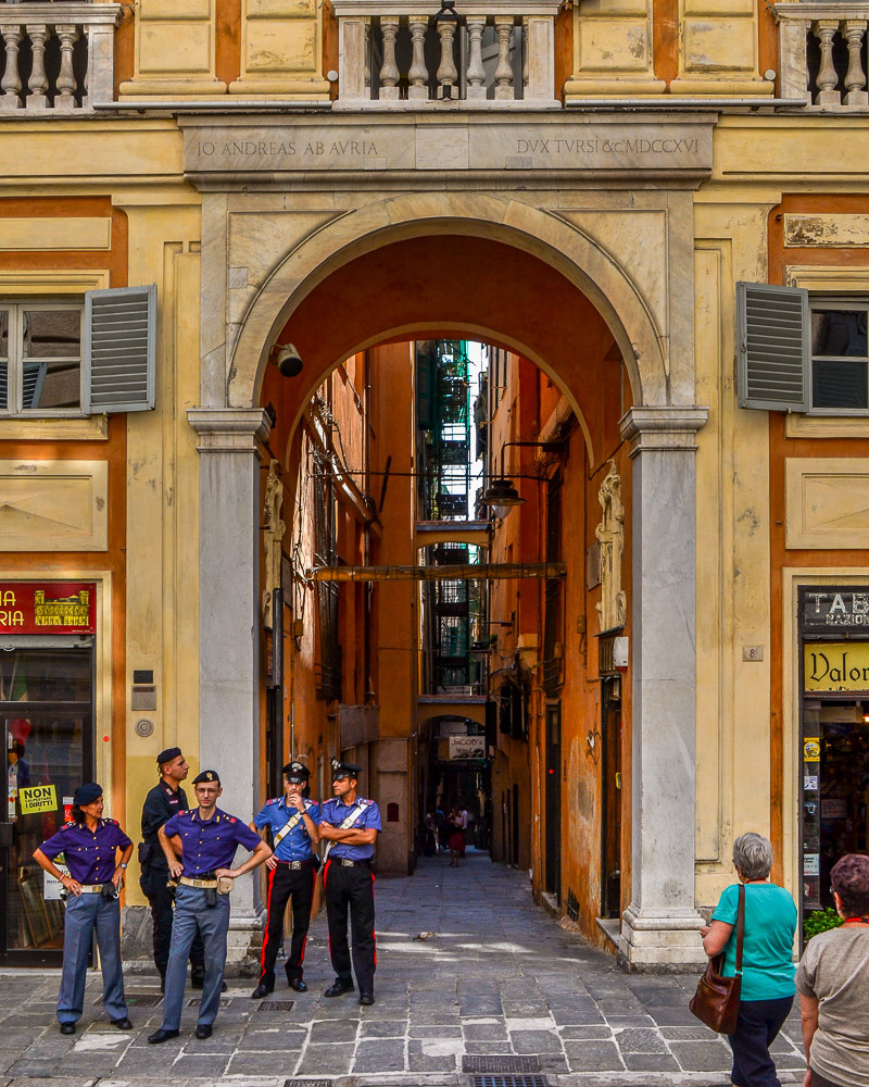 Carabinieri, splendid in their uniforns casually observe proceedings.