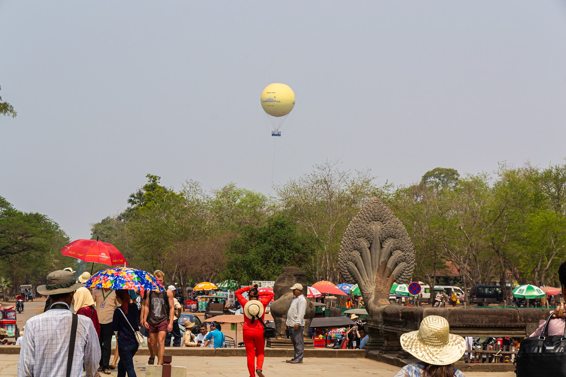A tethered balloon hovers above affording a birds-eye view of the temple ground.