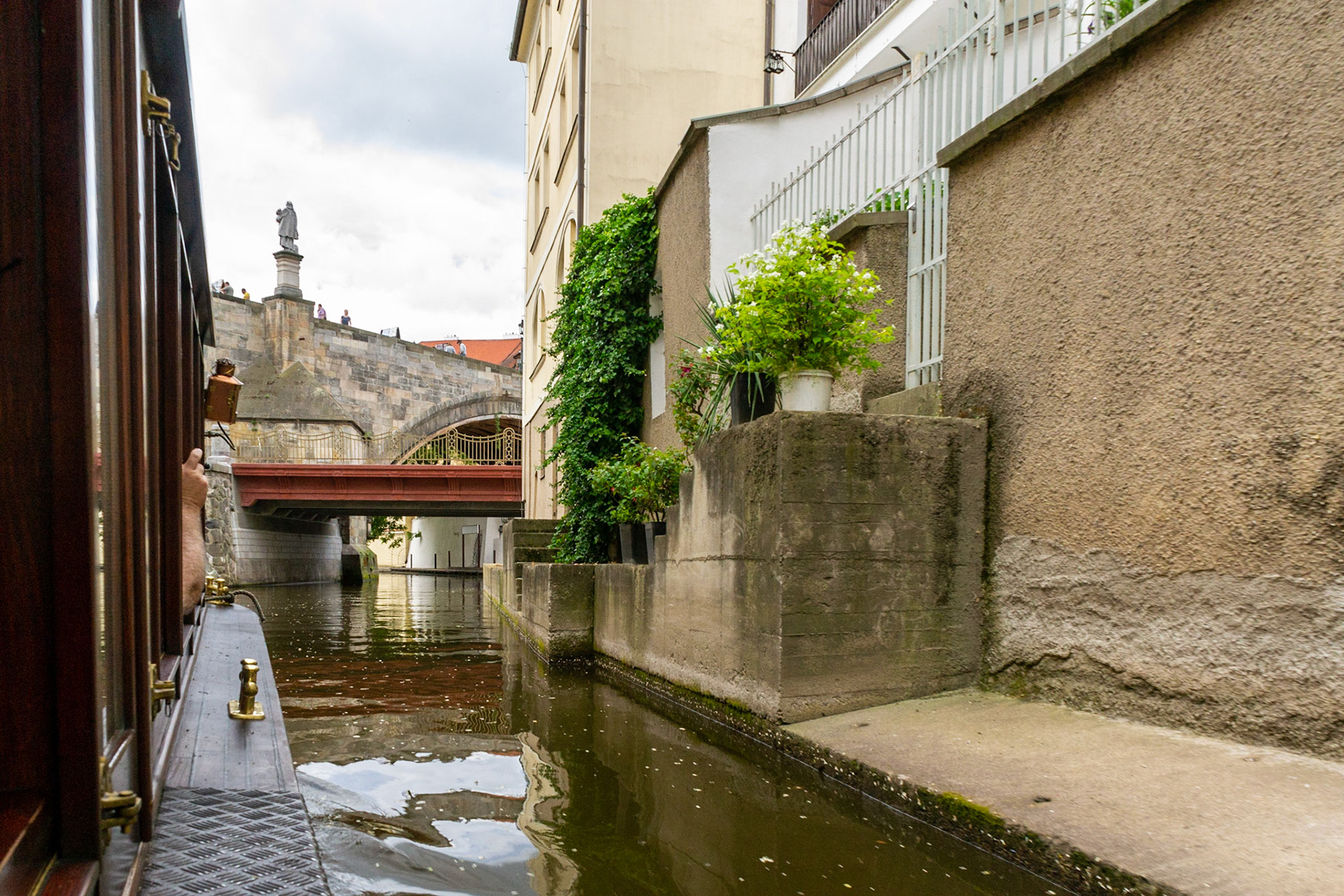 Cruising the Čertovka, picturesque man-made channel on the western side of the Vltava river. Ahead is the Charles Bridge.