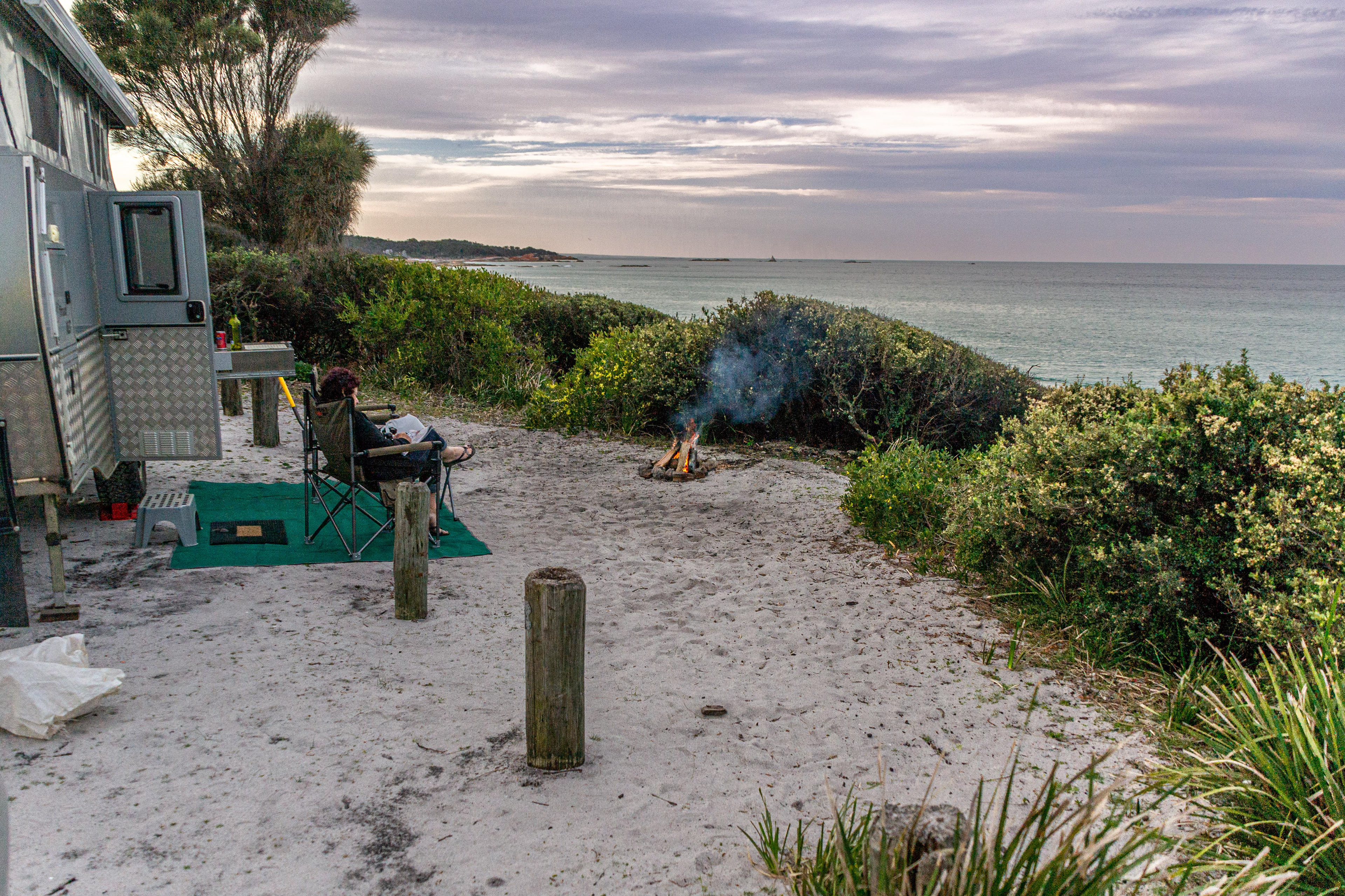 A top campsite right on the beach at Cosy Corner, St Helens - however as the fire suggests the weather is not too cosy.