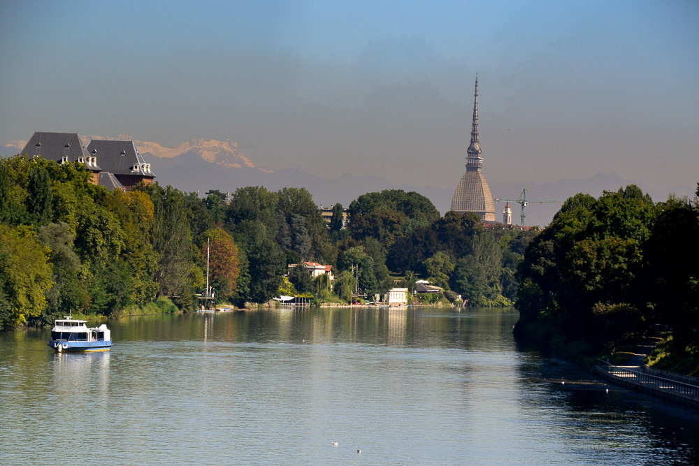 The river Po with the symbol of Turin, the Mole Antonelliana, and Snow capped Alps in the distance.