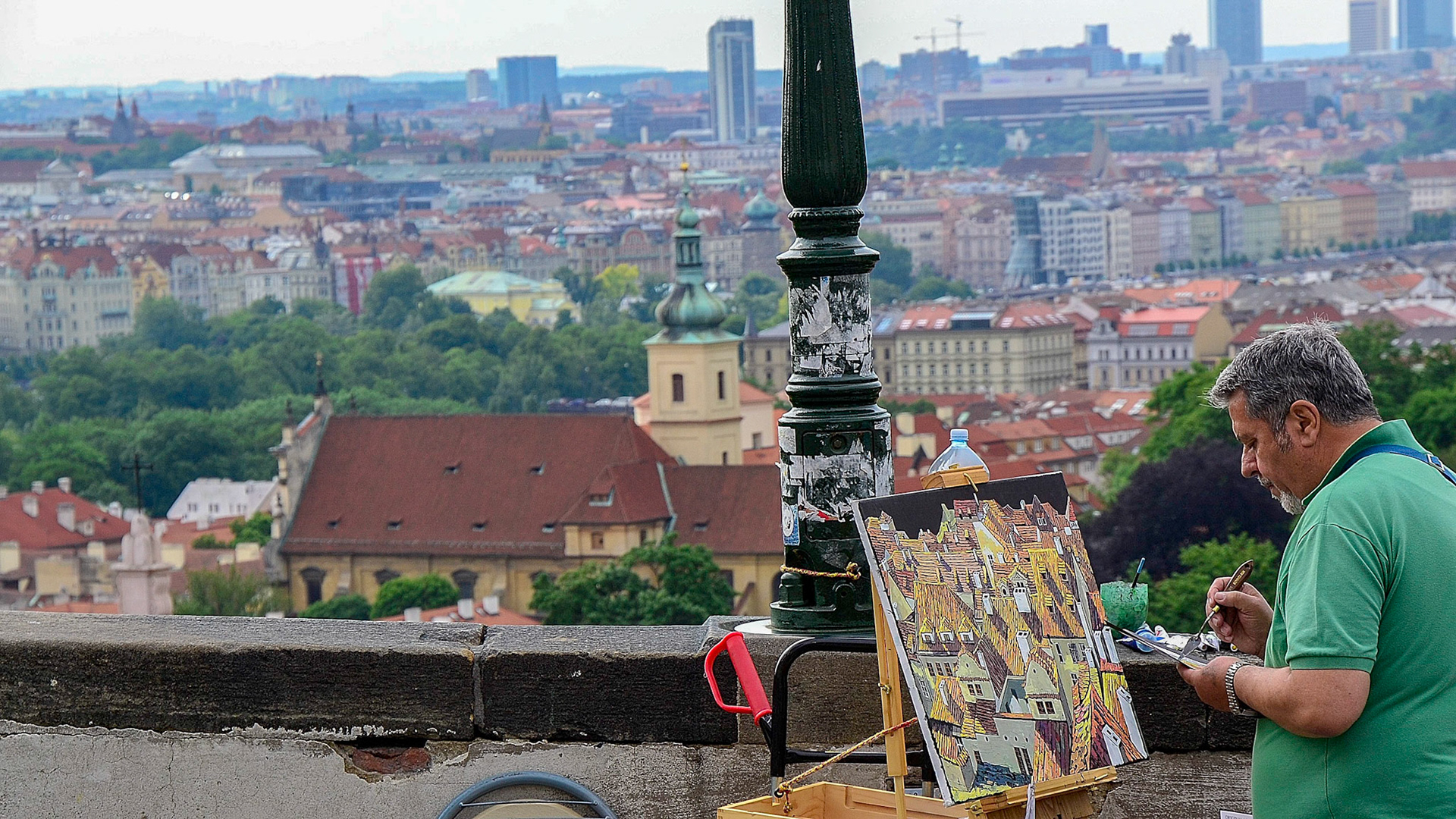A local artist captures the cityscape below Prague Castle