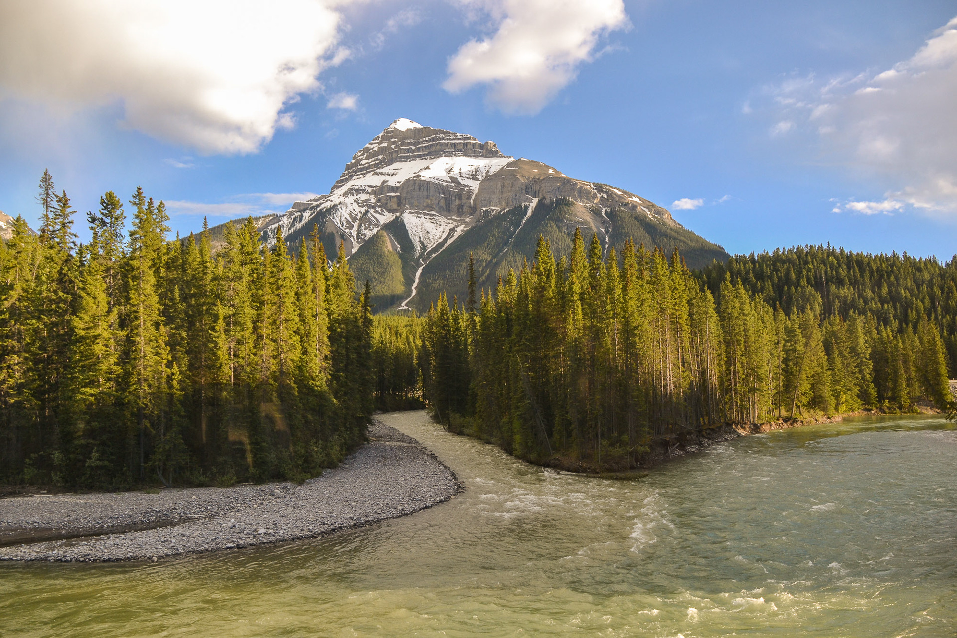 Snow melt feeds into the river from mountain streams.