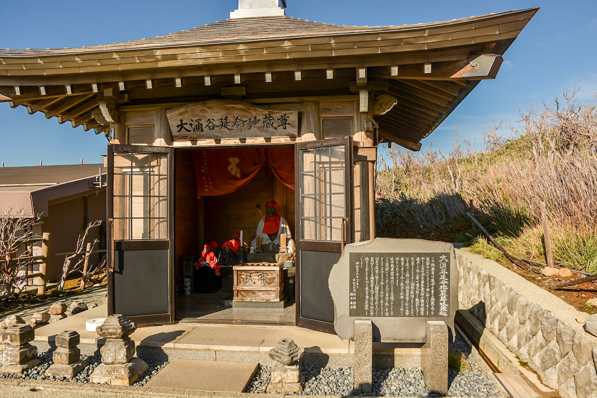 The Enmei Jizo (Jizo statue of long life) sits in front of Owakudani's smoky grounds.