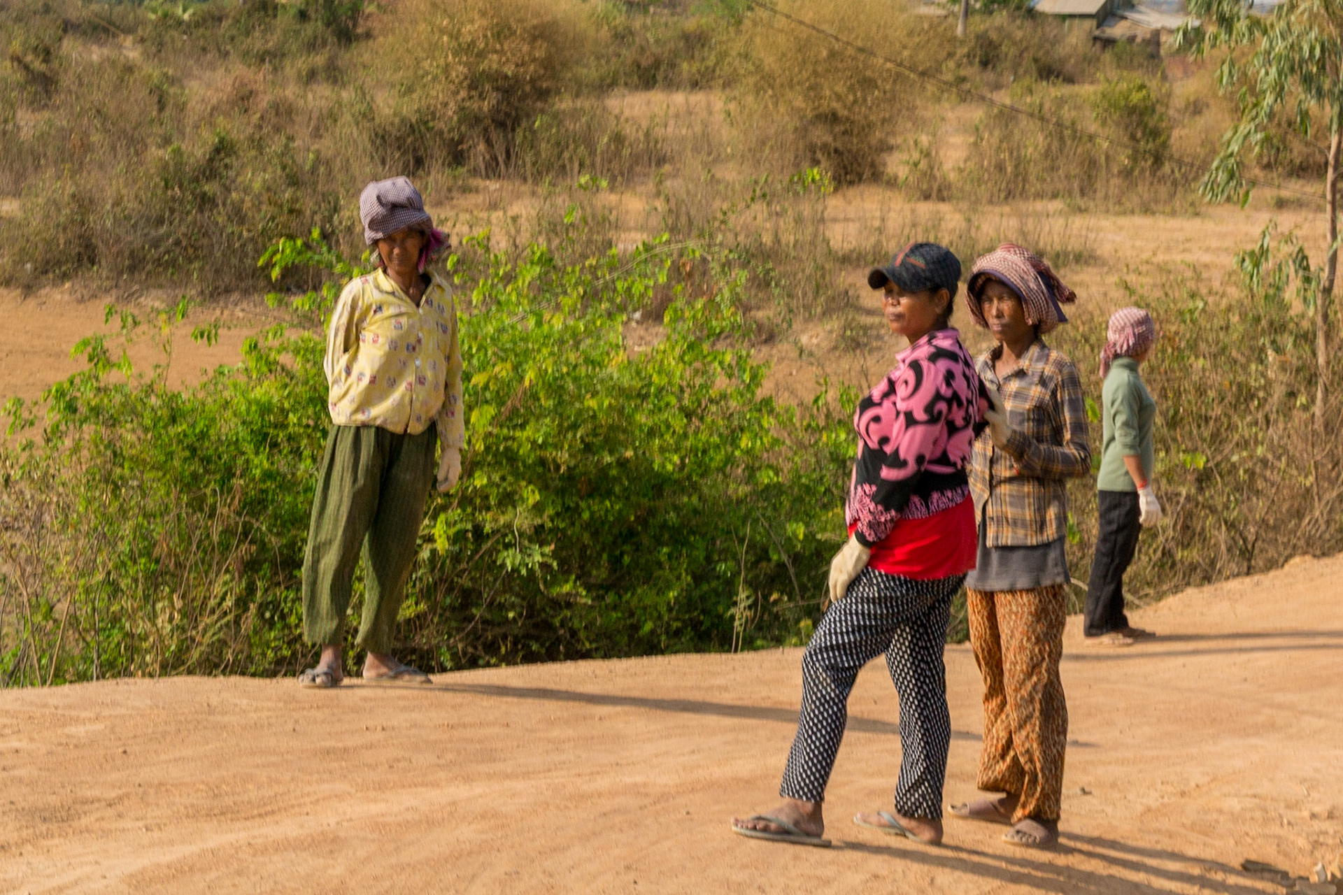 Workers wait for local transport to arrive.