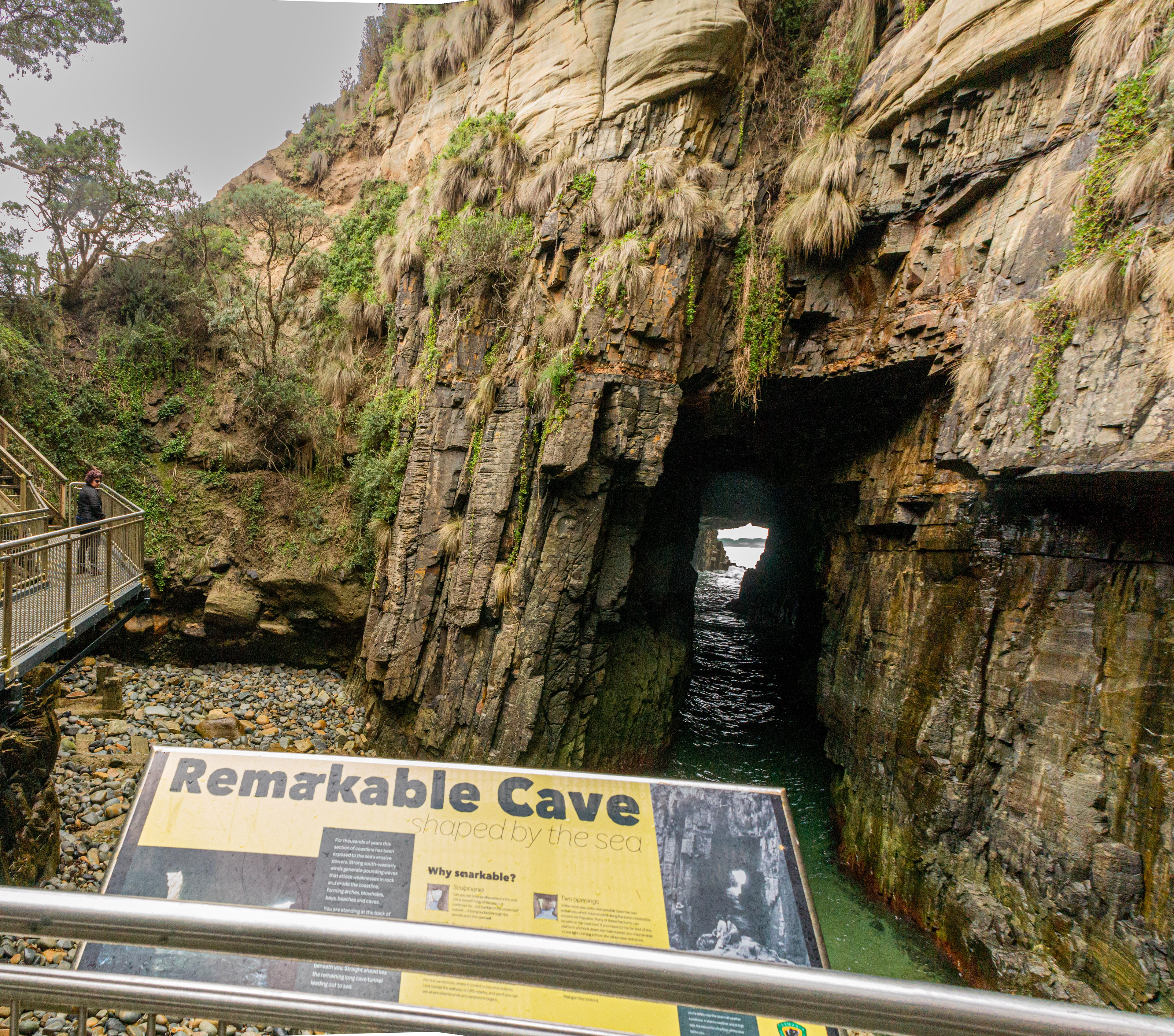 Remarkable cave in the background. Unlike most sea caves, Remarkable Cave features two ocean-facing entrances caused by erosion along fractures created by ancient earth quakes.