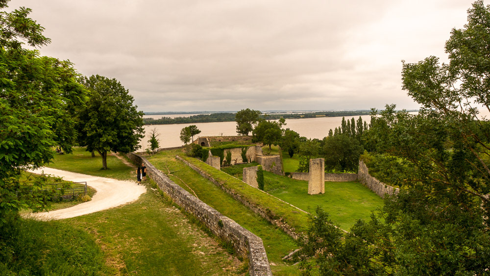 Gardens and disused magazine bunkers below the main wall with the Gironde in the background.