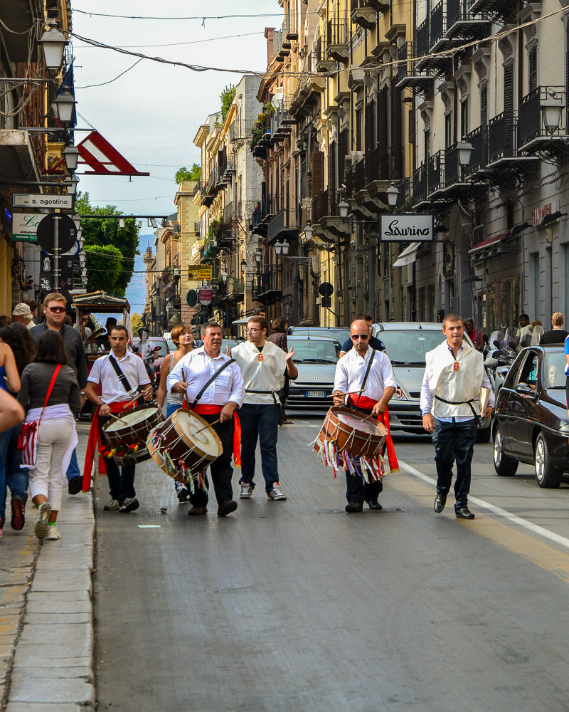 Drummers marching through the narrow streets of old Palermo.
