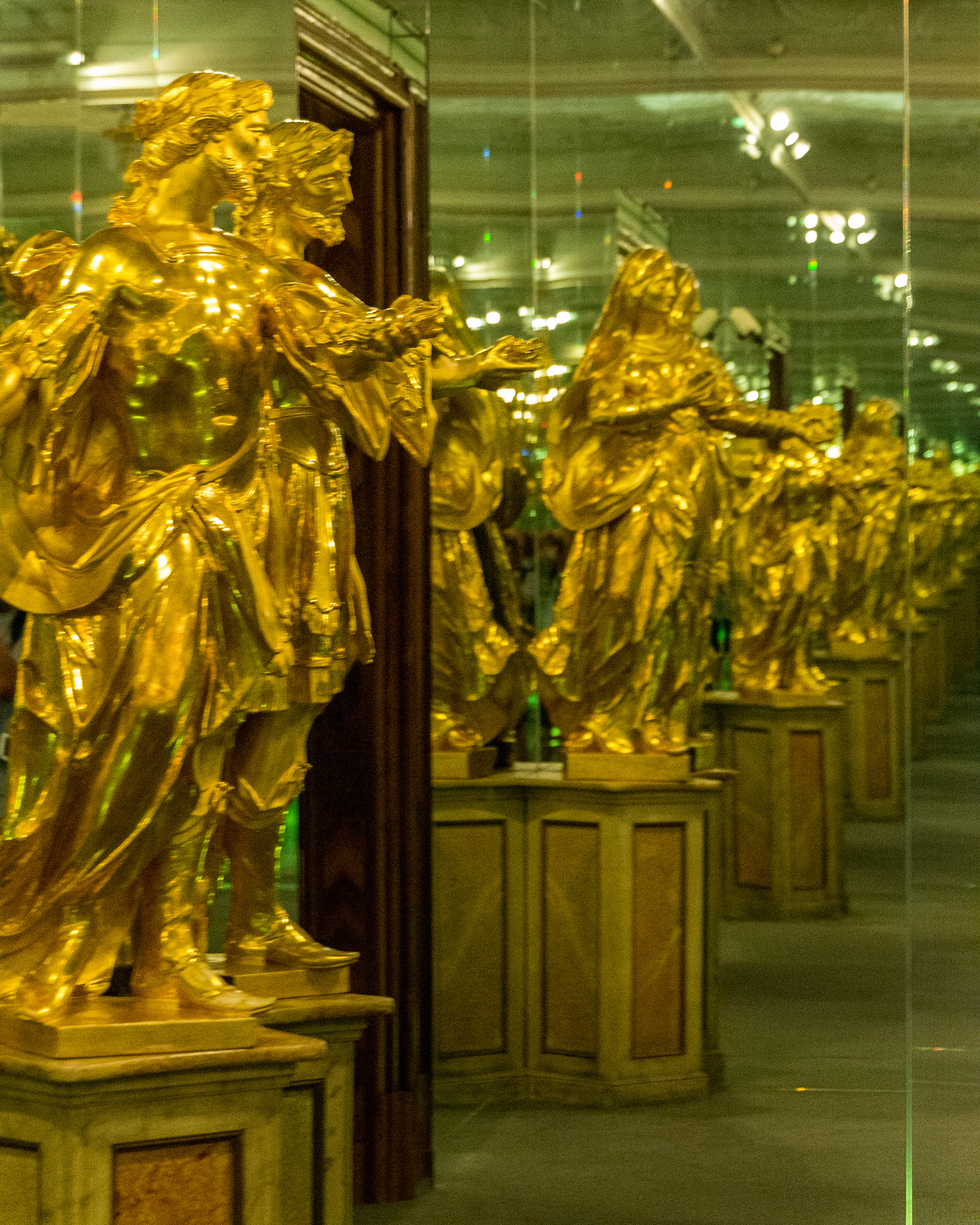 Mirror maze effect multiplies this gilded statue.