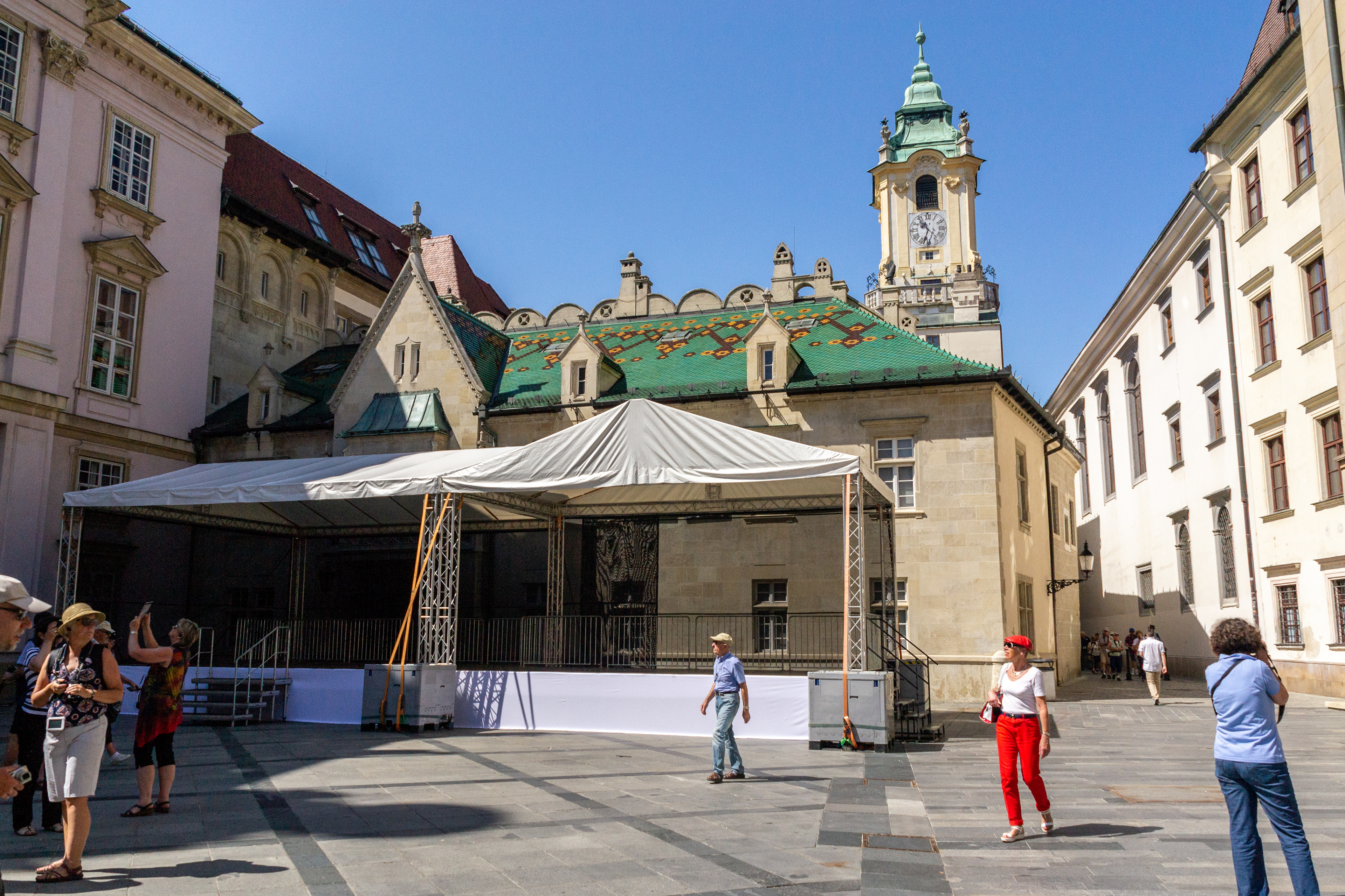 The clocktower looms above the patterned tiled roofline of the Town Hall. It is the oldest city hall in the country and it is one of the oldest stone buildings still standing in Bratislava, with the tower being built approximately in 1370.