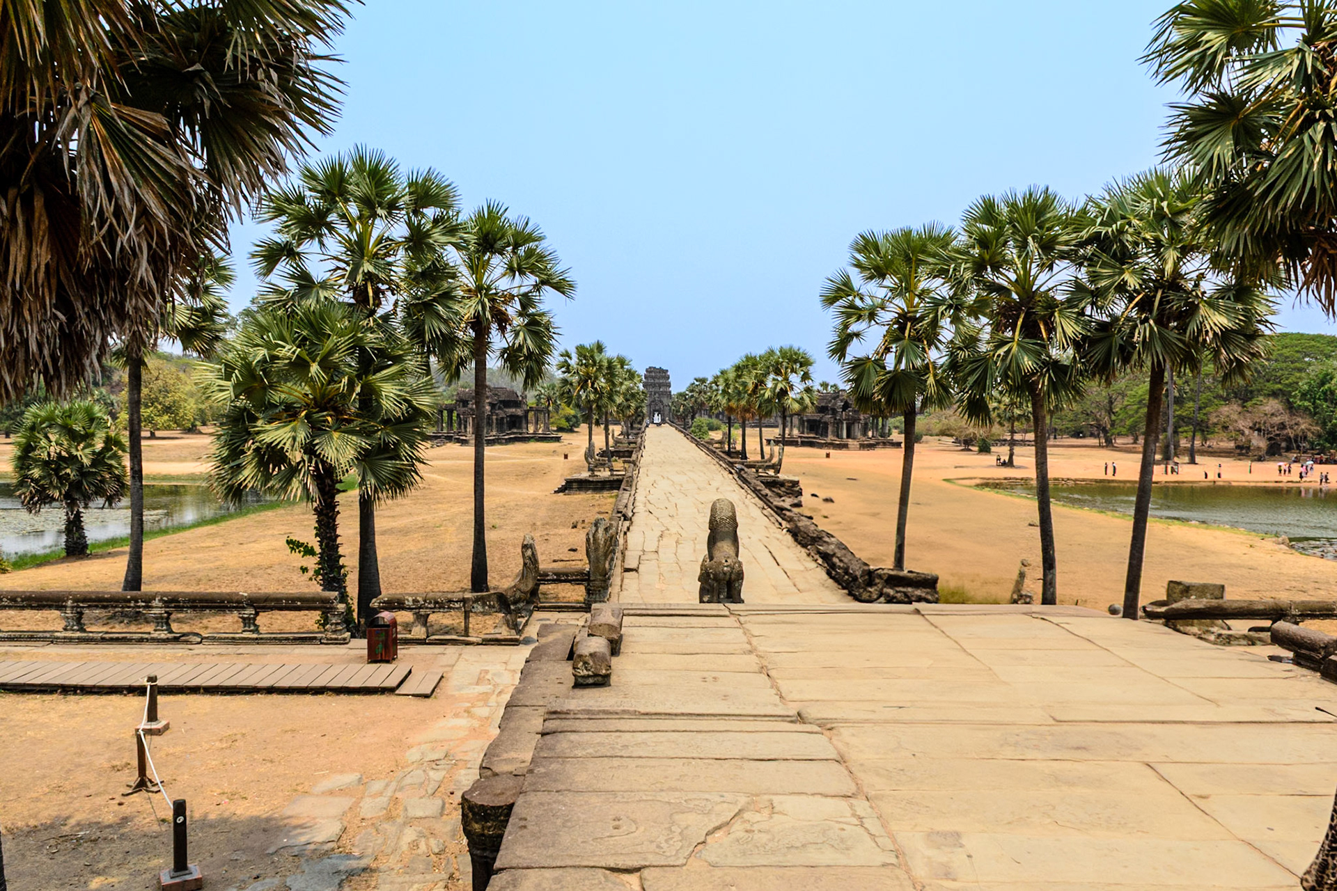 Approaching Angkor Wat via the paved, tree lined avenue and causeway.