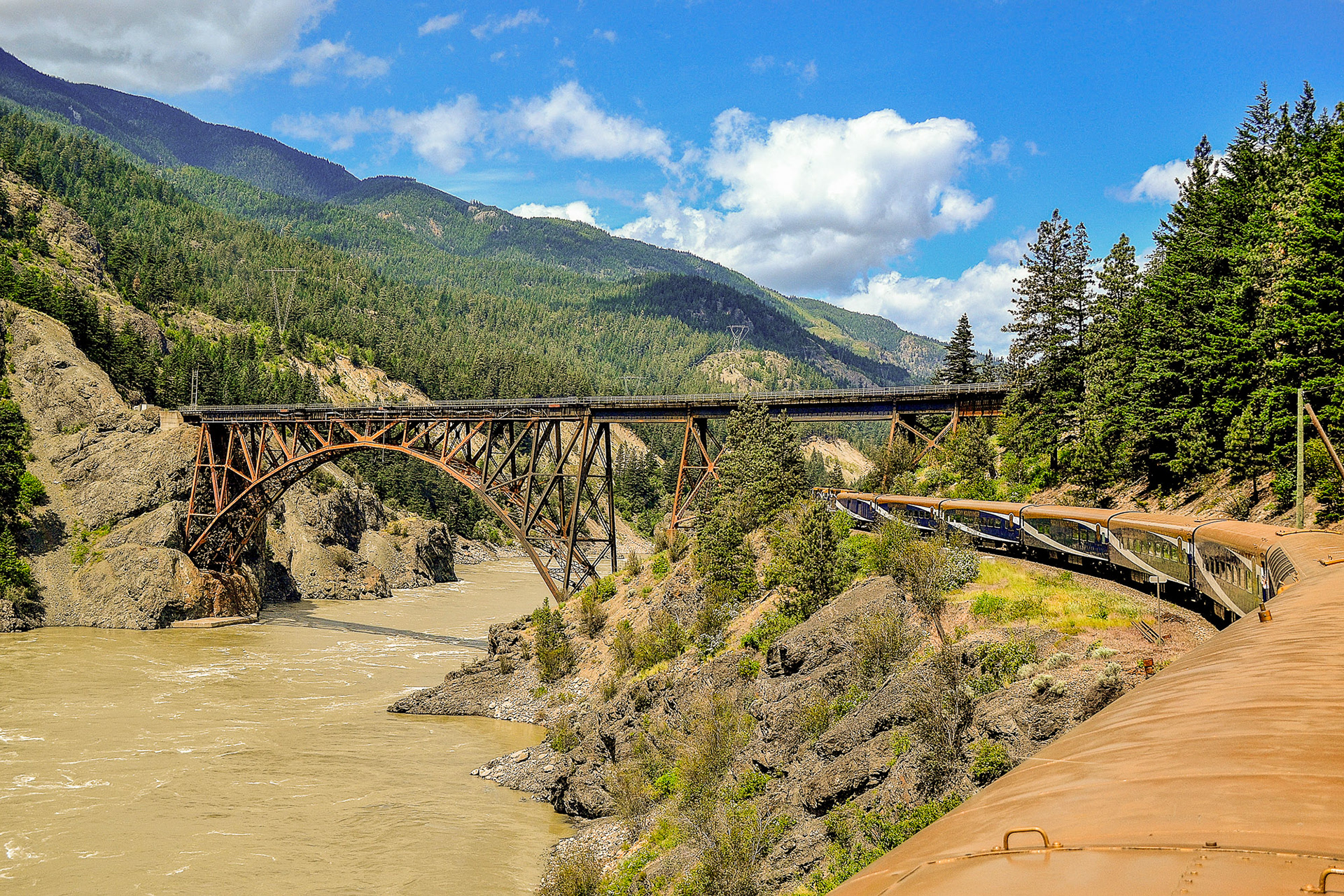 Our train passes under the Cisco truss arch bridge at Siska, British Columbiaafter crossing a 3-span truss bridge over the Fraser River.