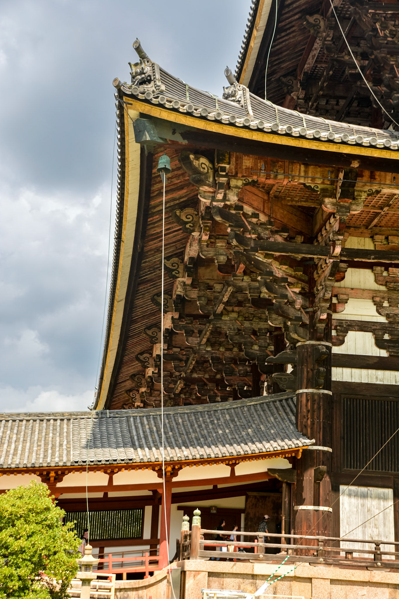 Intricate timber framing of the roof outriggers supporting the overhanging eaves.