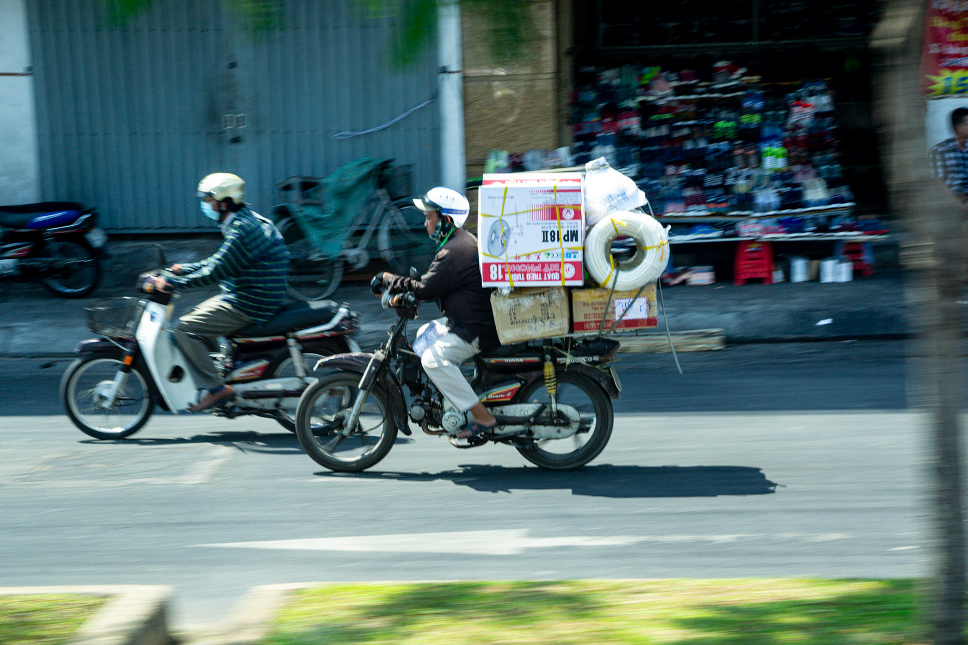 Motorcycle transport of all forms dominates the city streets.