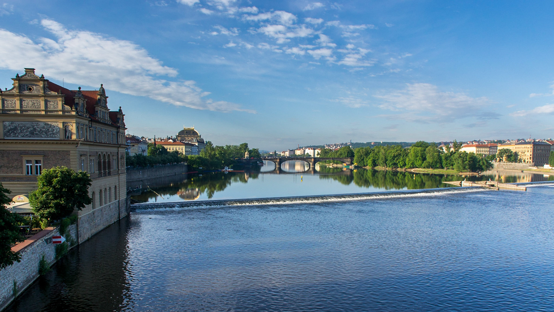 Vltava River reflections looking upstream from Charles Bridge.