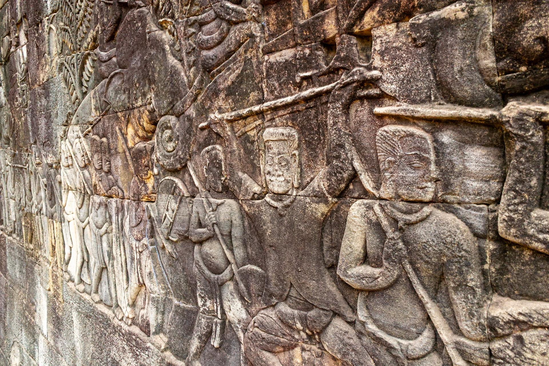 Bas-relief images carved into sandstone blocks depict fearsome battles.