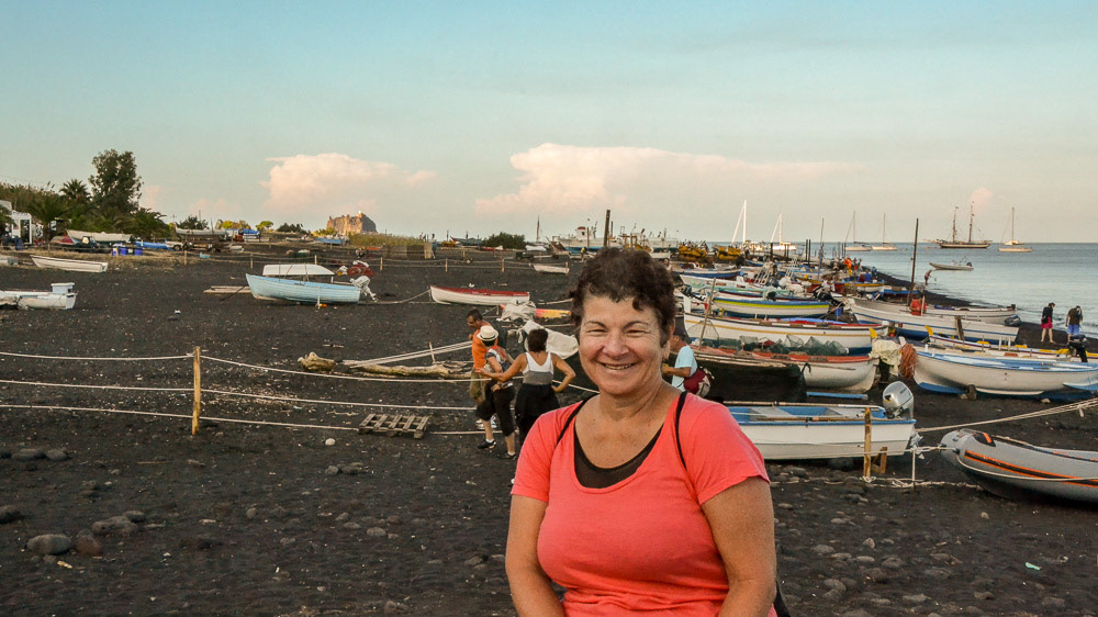 Cheryl on the black volcanic beach of San Bartolo on Stromboli.
