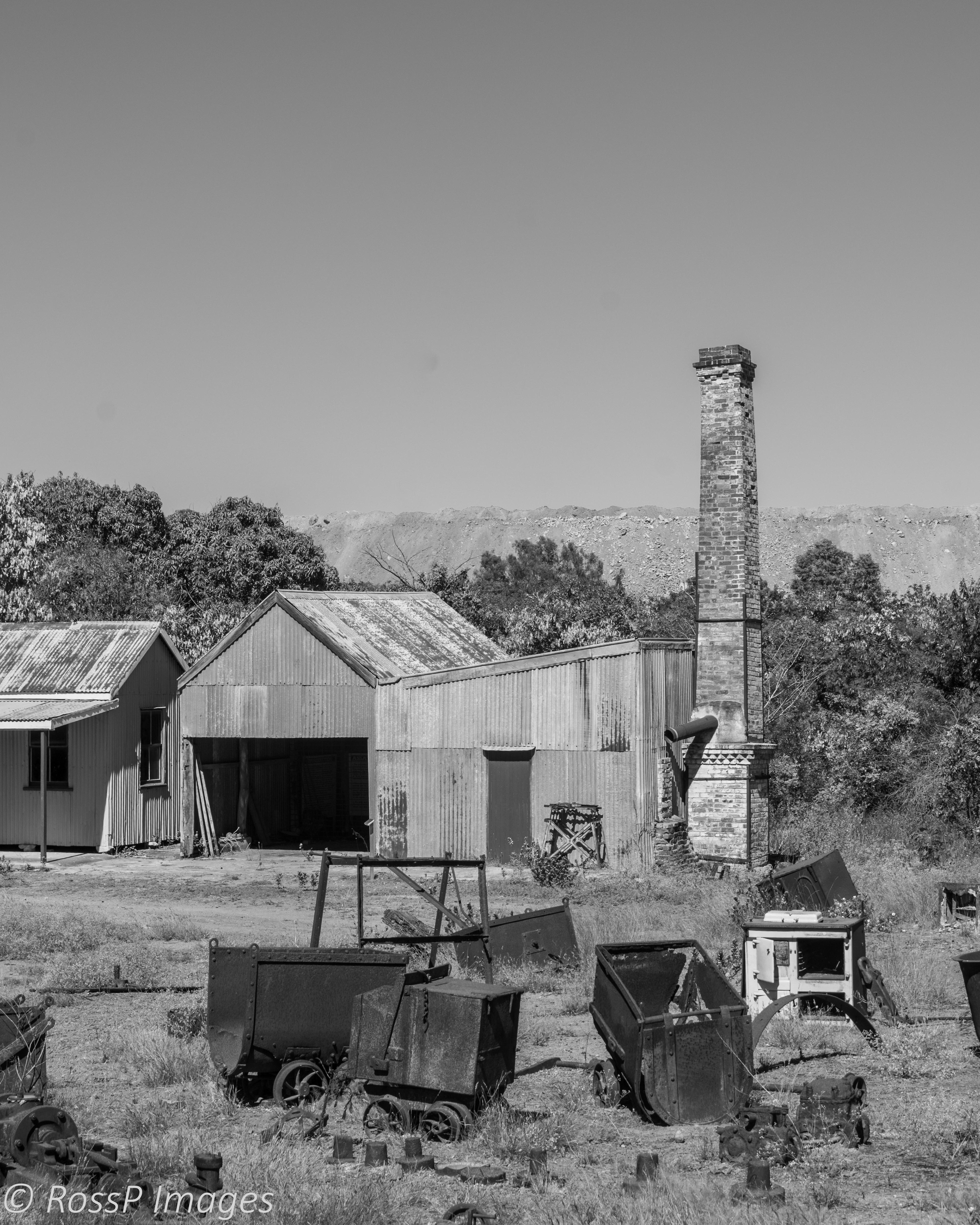 Mabel Mill of the New Ravenswood Company. Office and Assay House with the current open cut mining operations in the background.