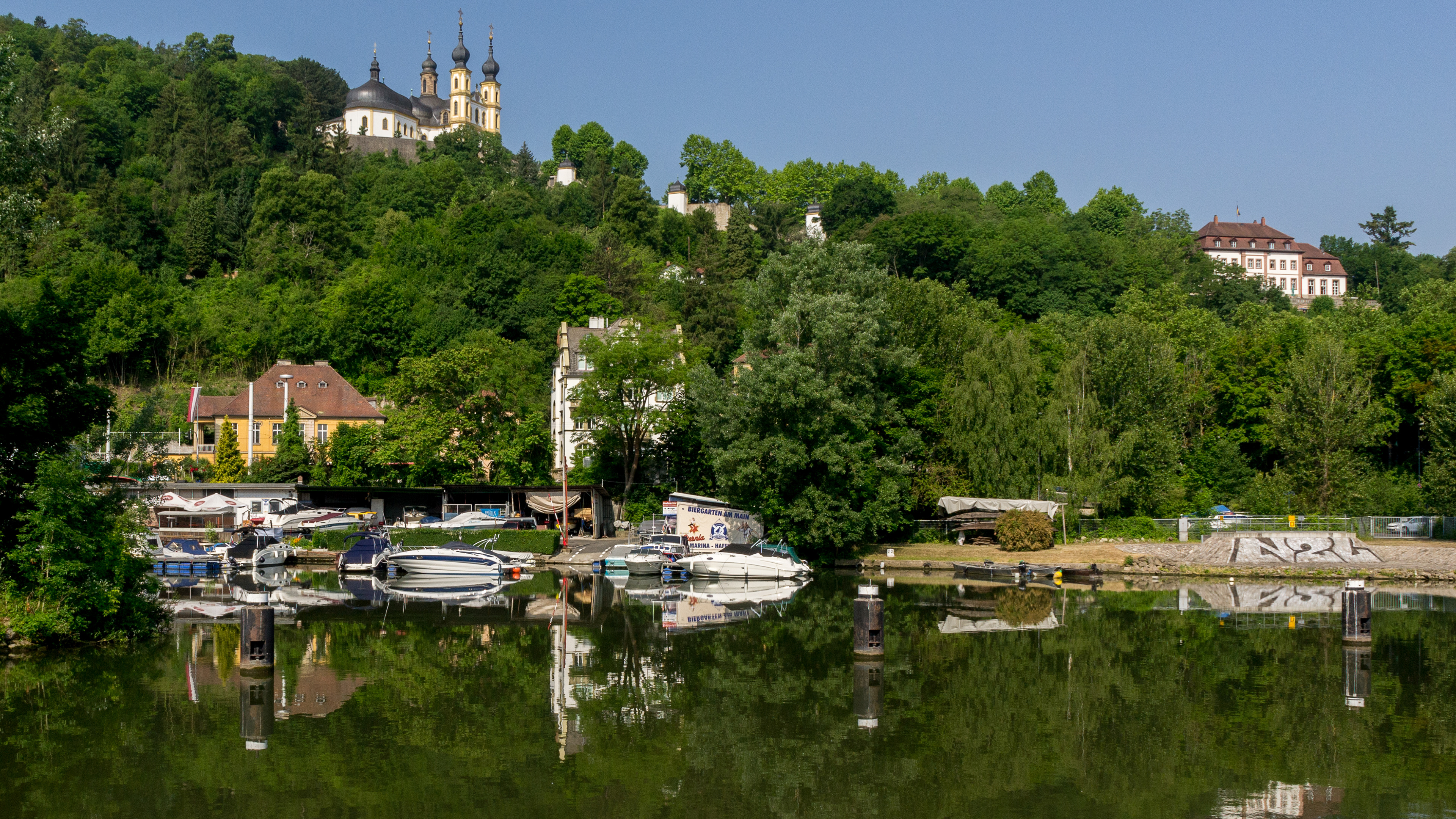 Reflections inthe River Main. Above on the hill is The Käppele ('Little Chapel'), the commonly used name for the Wallfahrtskirche Mariä Heimsuchung.