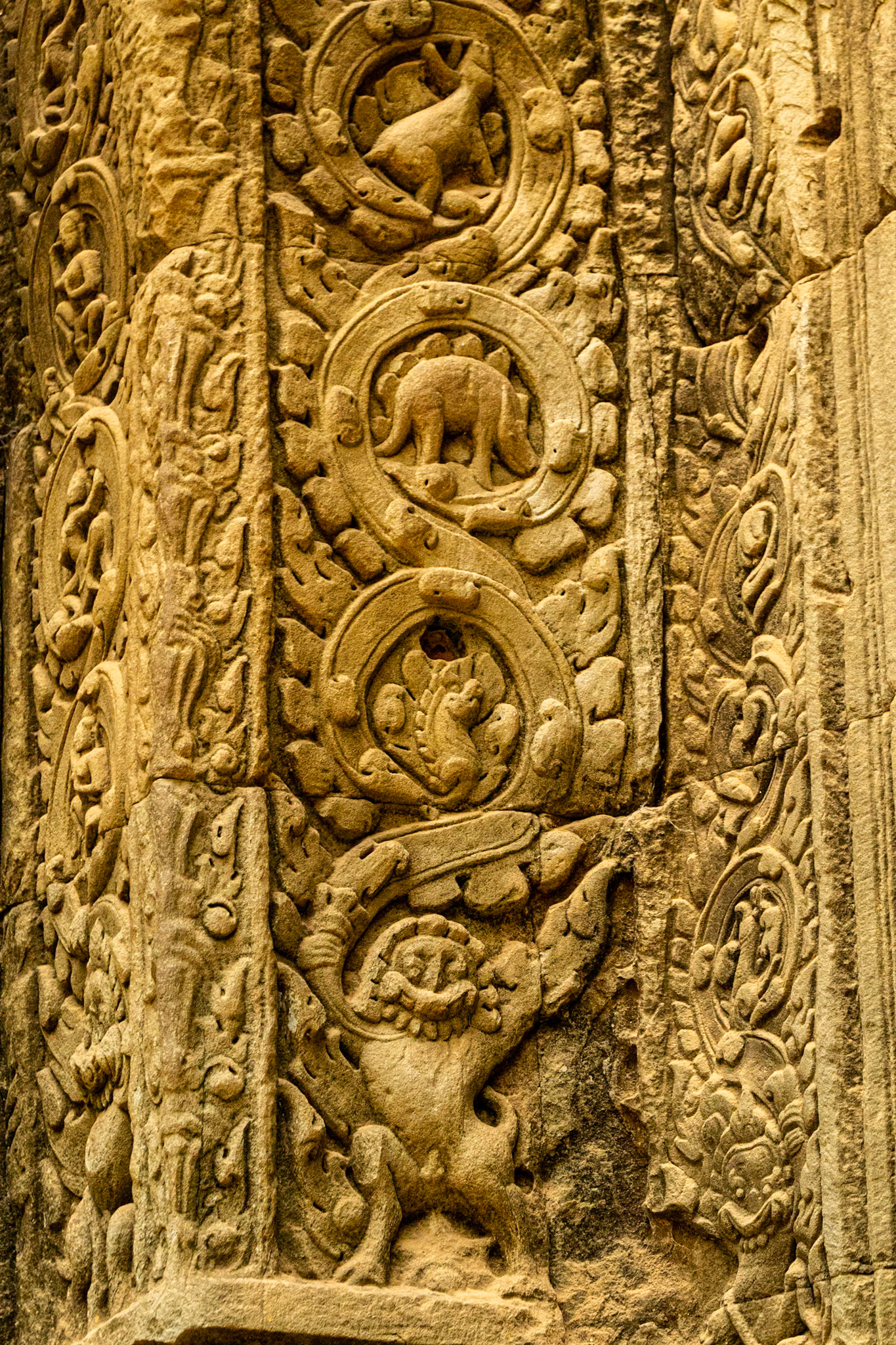 Bas relief figures carved into sandstone blocks.