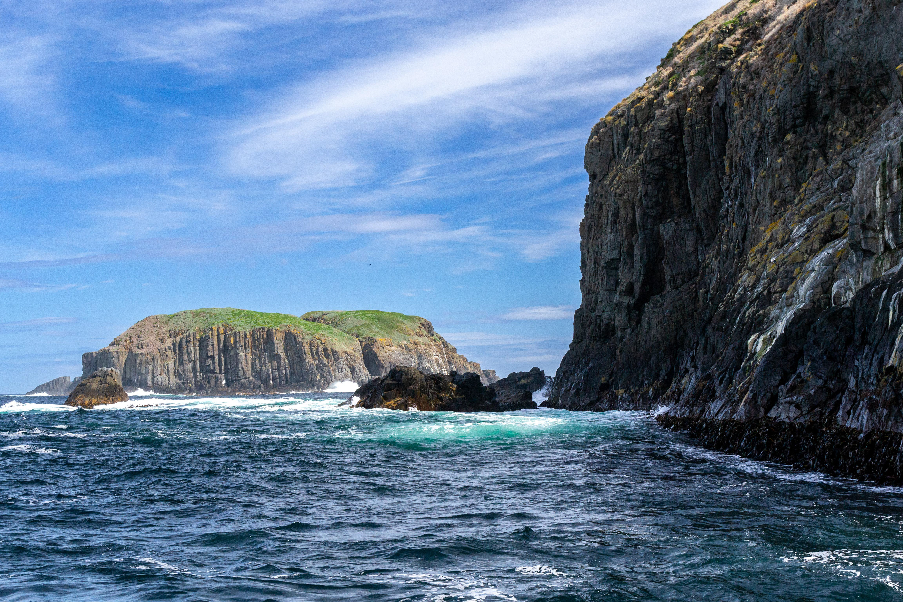 Uninhabited islands rise from the ocean at the southern tip of Bruny Island.
