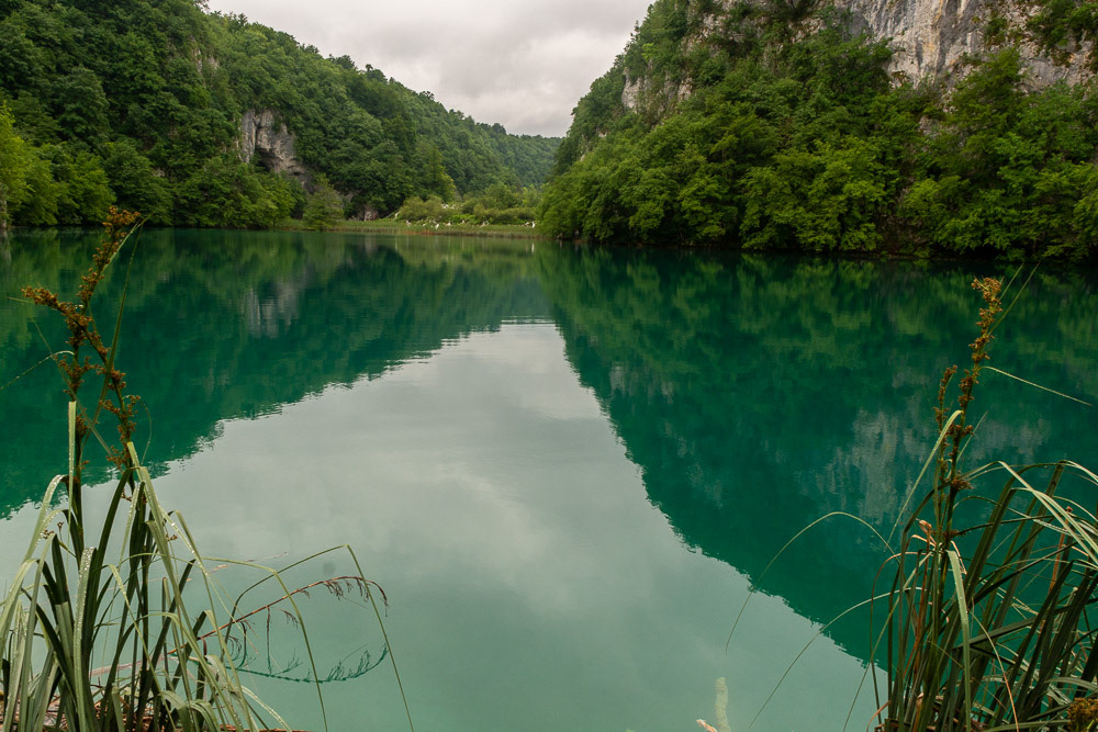Reflections of the lower canyon walls in the still emerald green water.