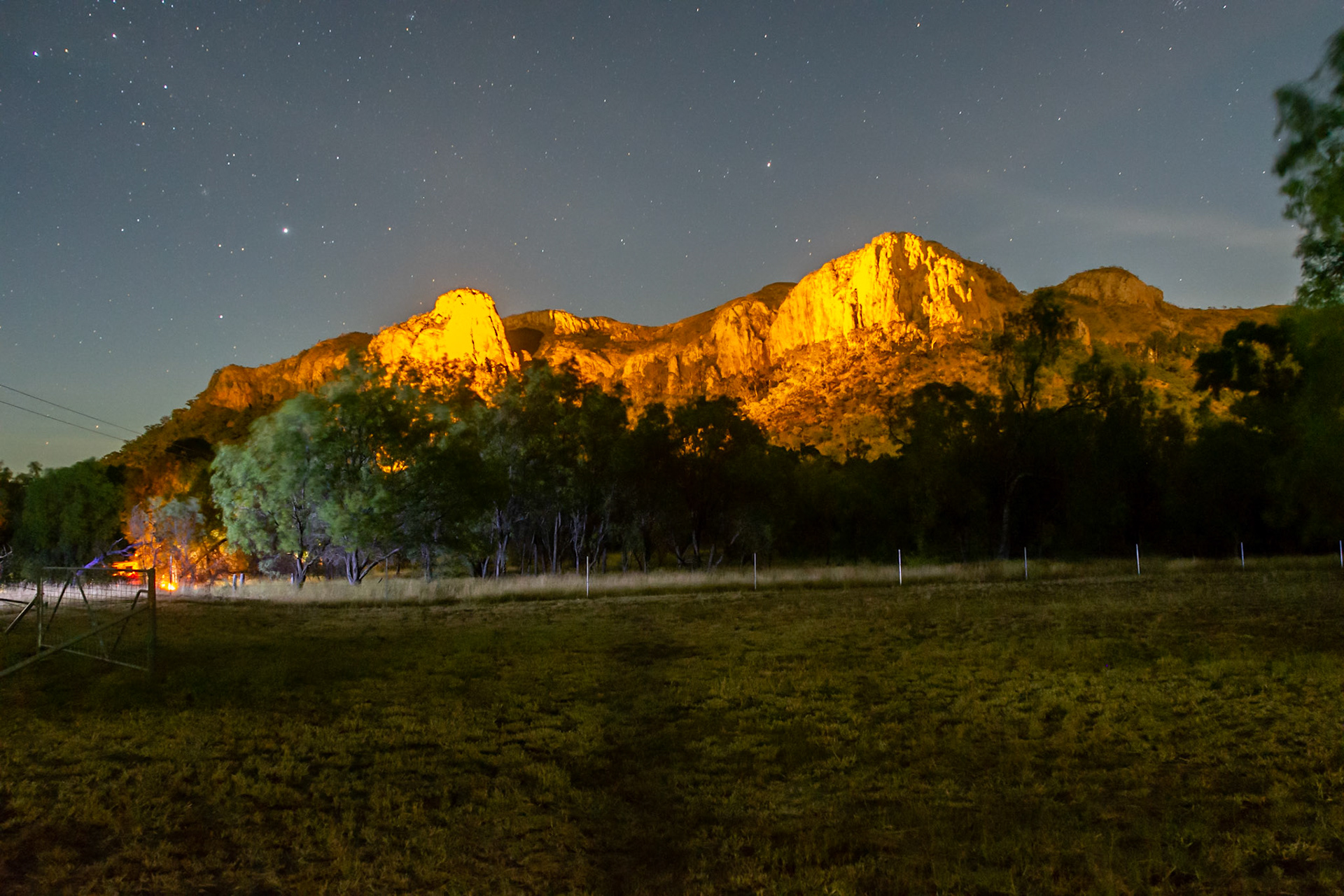 Virgin Rock is lit up at night providing a scenic backdrop to our campsite.