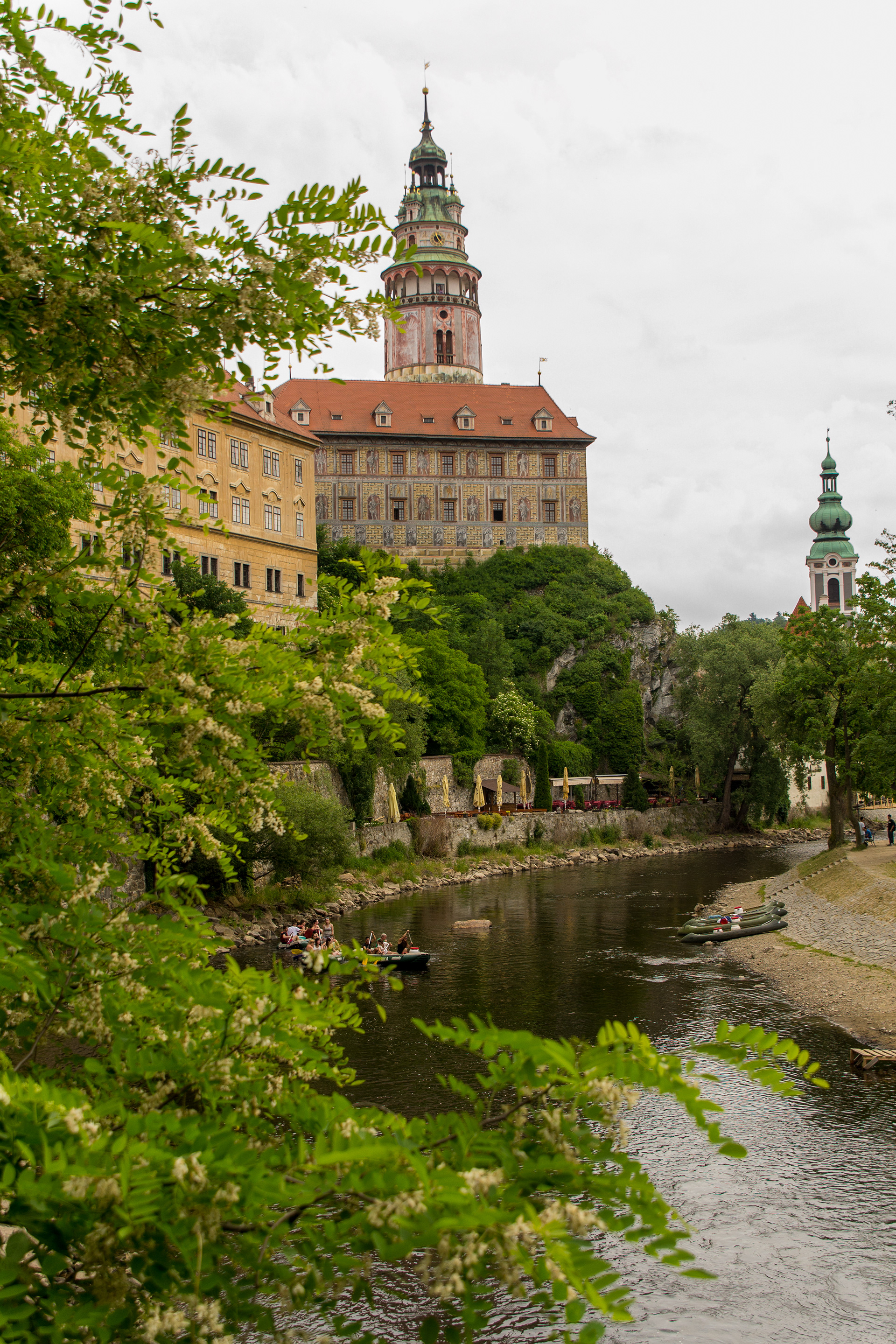 Krumlov Castle above the Vltava River. On the left side is the oldest part of the castle (Hrádek), an old palace with a tower from the 13th century.