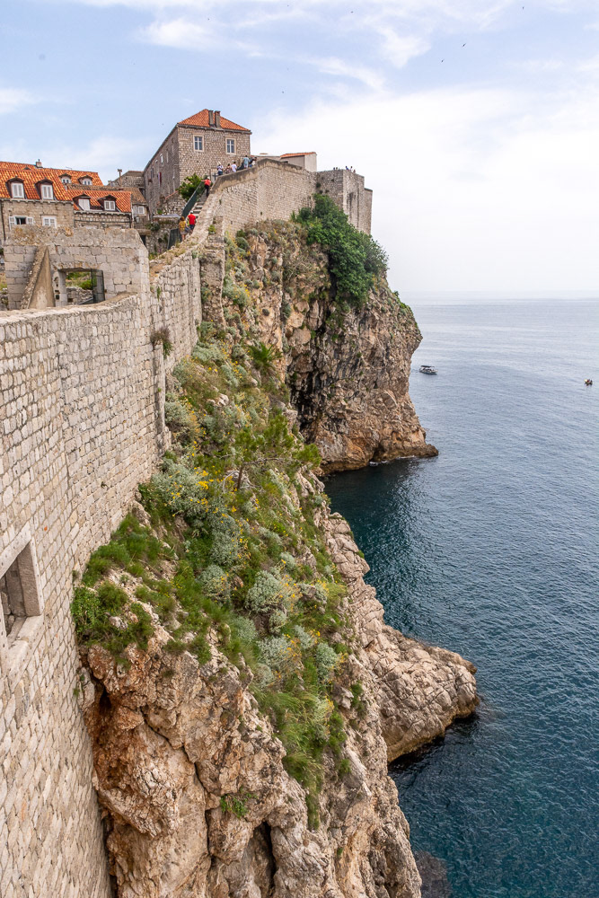 Stone walls rising high above rocky cliffs provide an inpenetrable defence from the sea.
